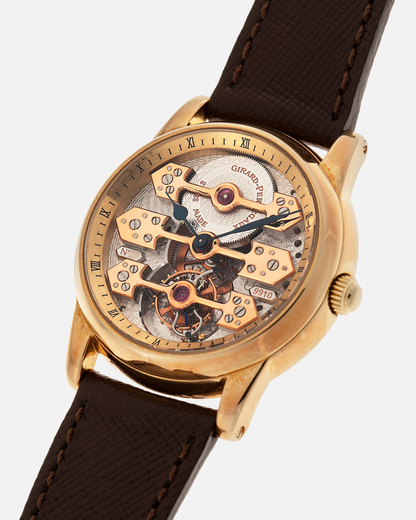 Brand: Girard Perregaux  Year: Mid-1990s Model: Three Bridges Tourbillon, “Tourbillon Sous Trois Ponts d'Or” Reference: 99000 Material: 18-carat Yellow Gold  Movement: Girard Perregaux Cal. 9910 Tourbillon, Manual-Winding  Case Dimensions: 39mm x 10.5mm (Lug-to-Lug 44.5mm)  Lug Width: 20mm  Strap: Phillips Dark Brown Textured Calf Leather Strap with Signed 18-carat Yellow Gold Tang Buckle 