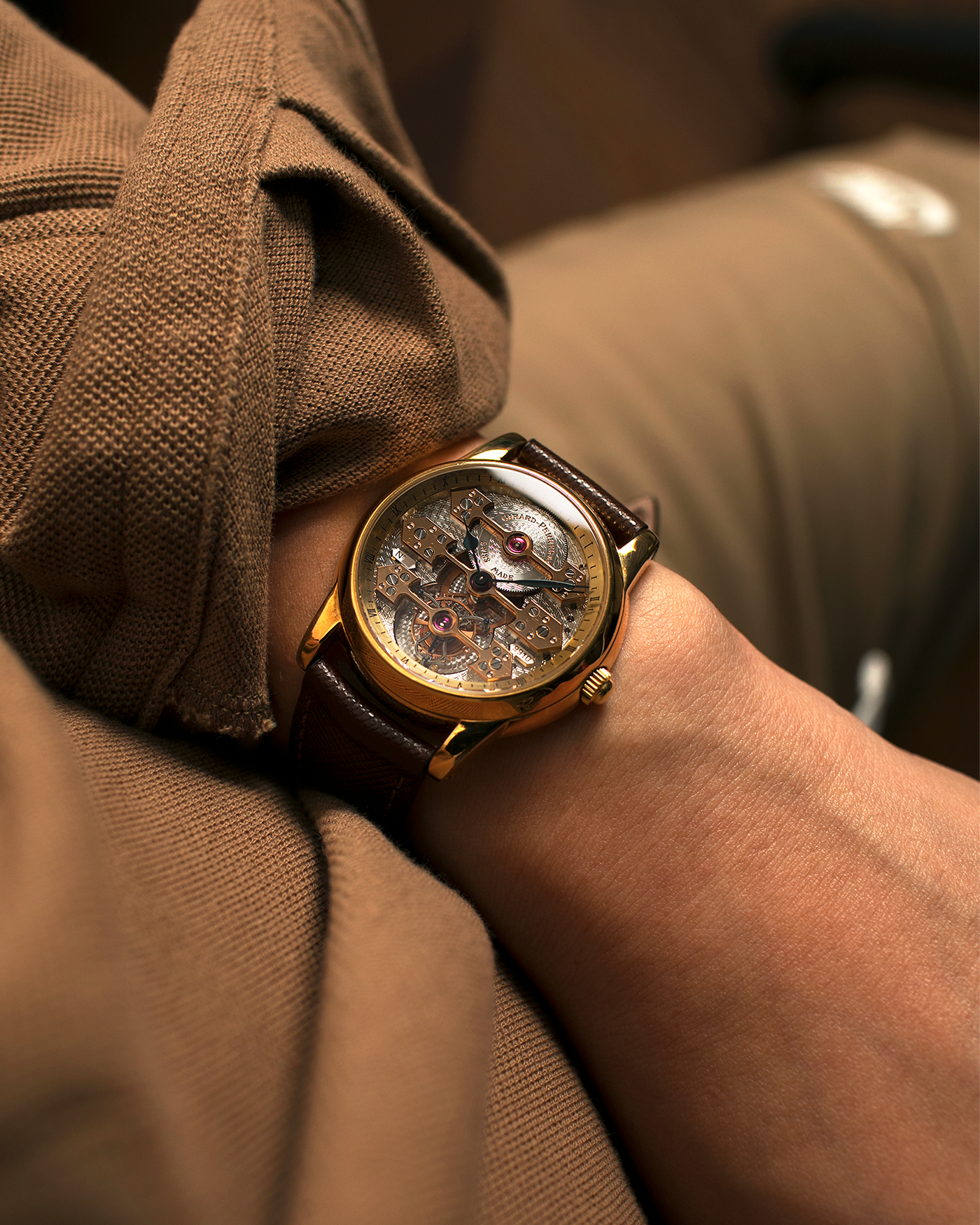Brand: Girard Perregaux  Year: Mid-1990s Model: Three Bridges Tourbillon, “Tourbillon Sous Trois Ponts d'Or” Reference: 99000 Material: 18-carat Yellow Gold  Movement: Girard Perregaux Cal. 9910 Tourbillon, Manual-Winding  Case Dimensions: 39mm x 10.5mm (Lug-to-Lug 44.5mm)  Lug Width: 20mm  Strap: Phillips Dark Brown Textured Calf Leather Strap with Signed 18-carat Yellow Gold Tang Buckle 