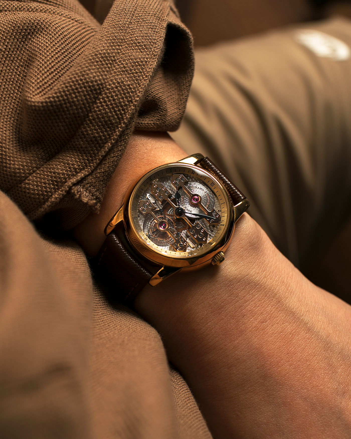 Brand: Girard Perregaux  Year: Mid-1990s Model: Three Bridges Tourbillon, “Tourbillon Sous Trois Ponts d'Or” Reference: 99000 Material: 18-carat Yellow Gold  Movement: Girard Perregaux Cal. 9910 Tourbillon, Manual-Winding  Case Dimensions: 39mm x 10.5mm (Lug-to-Lug 44.5mm)  Lug Width: 20mm  Strap: Phillips Dark Brown Textured Calf Leather Strap with Signed 18-carat Yellow Gold Tang Buckle 