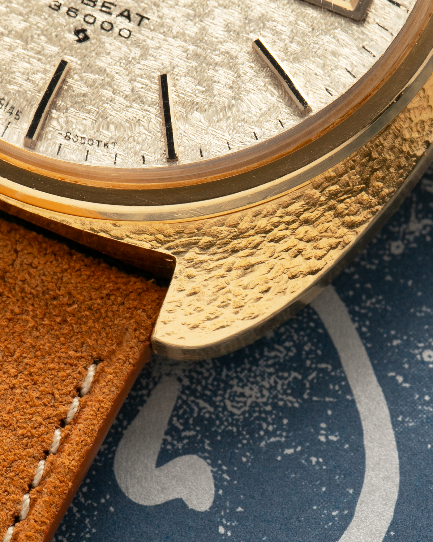 Brand: Grand Seiko
Year: Late 1960’s/1970’s
Model: 61GS
Reference Number: 6145-8030 ‘Kirazuri’
Material: 18-carat Yellow Gold
Movement: Self-Winding Hi Beat Cal. 6145
Case Dimensions: 37mm Diameter 11mm Thickness
Lug Width: 18mm
Strap: Nostime Tan Suede Strap with Generic Stainless Steel Buckle