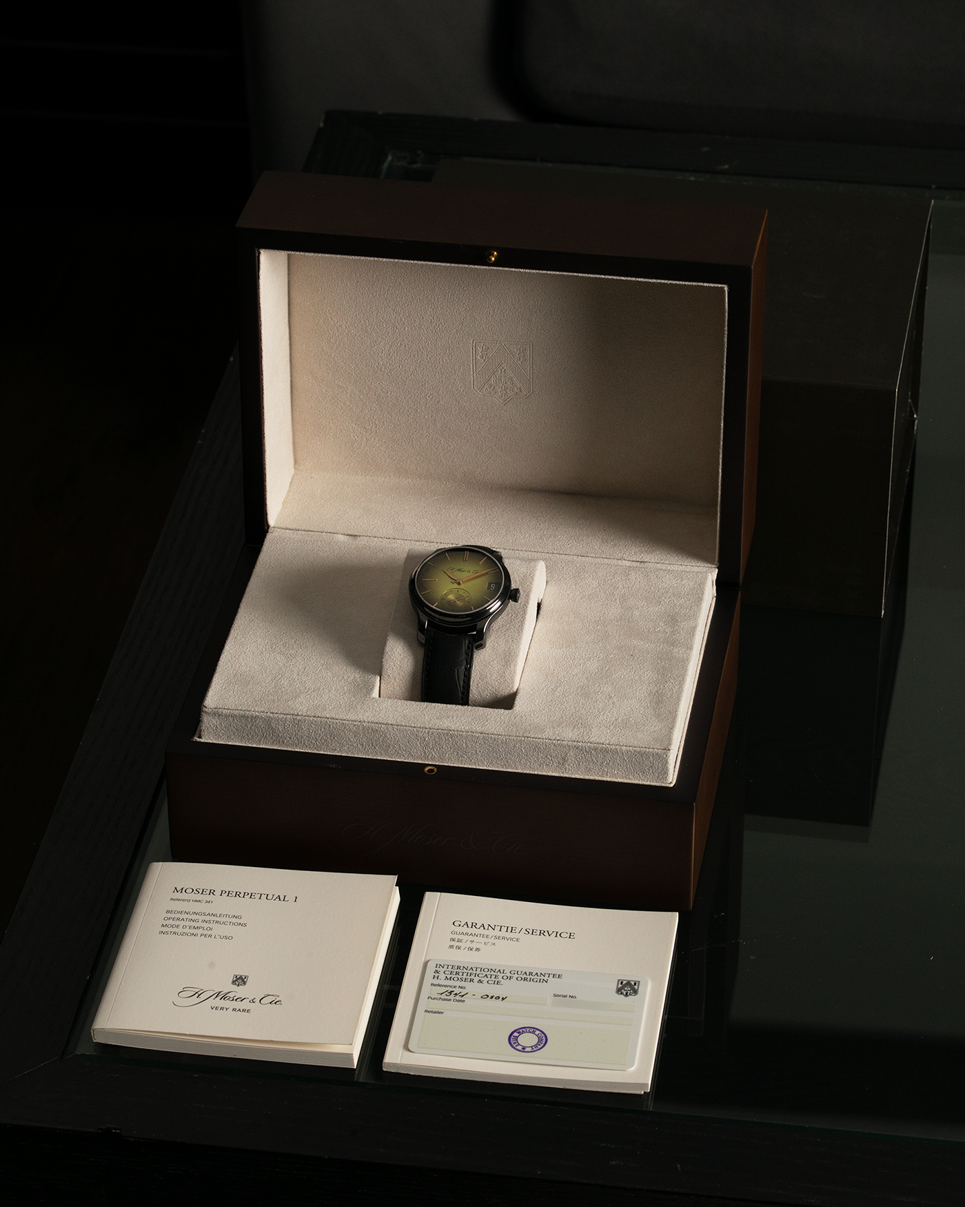Brand: H.Moser & Cie Year: 2020 Model: Endeavour Perpetual Calendar Yellow-Green Fumé Reference Number: 1344-0504 Material: DLC Coated Titanium Movement: H. Moser Cal. HMC 341, Manual-Winding Case Diameter: 40.8mm Lug Width: 20mm Strap: H. Moser & Cie Black Alligator Leather Strap with Signed DLC Coated Titanium Tang Buckle