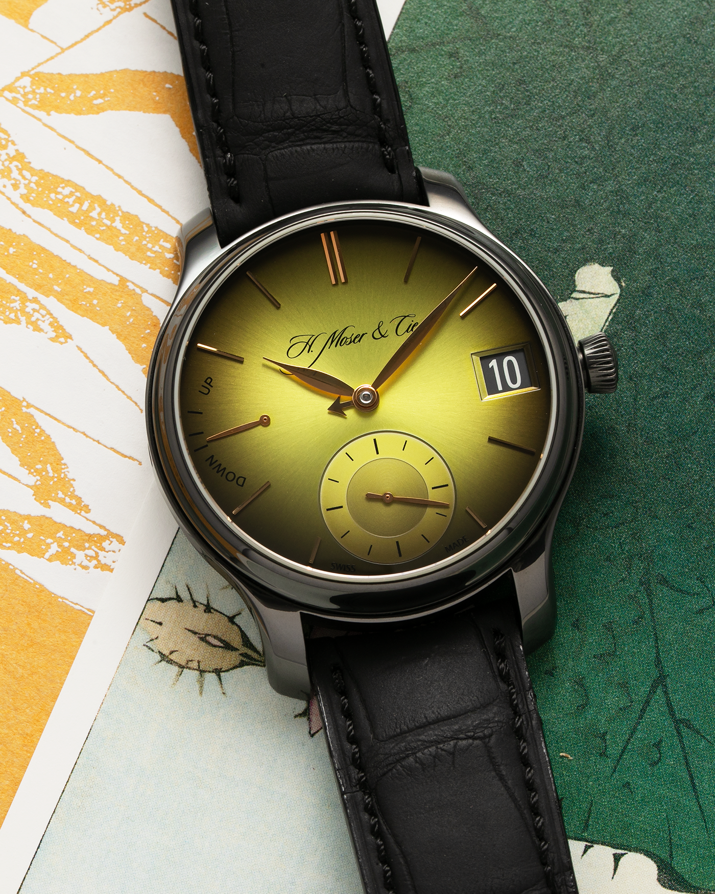 Brand: H.Moser & Cie Year: 2020 Model: Endeavour Perpetual Calendar Yellow-Green Fumé Reference Number: 1344-0504 Material: DLC Coated Titanium Movement: H. Moser Cal. HMC 341, Manual-Winding Case Diameter: 40.8mm Lug Width: 20mm Strap: H. Moser & Cie Black Alligator Leather Strap with Signed DLC Coated Titanium Tang Buckle