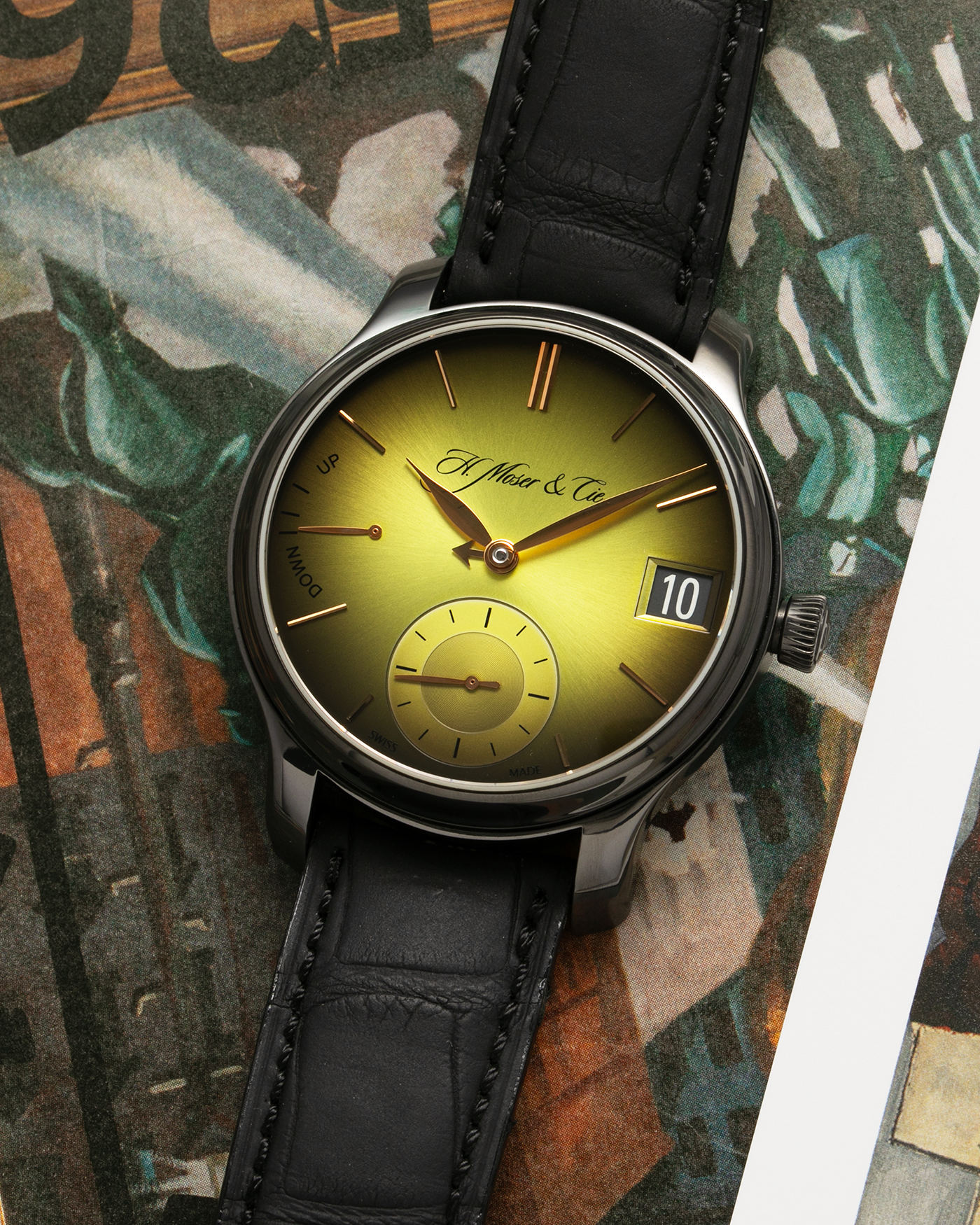 Brand: H.Moser & Cie Year: 2020 Model: Endeavour Perpetual Calendar Yellow-Green Fumé Reference Number: 1344-0504 Material: DLC Coated Titanium Movement: H. Moser Cal. HMC 341, Manual-Winding Case Diameter: 40.8mm Lug Width: 20mm Strap: H. Moser & Cie Black Alligator Leather Strap with Signed DLC Coated Titanium Tang Buckle