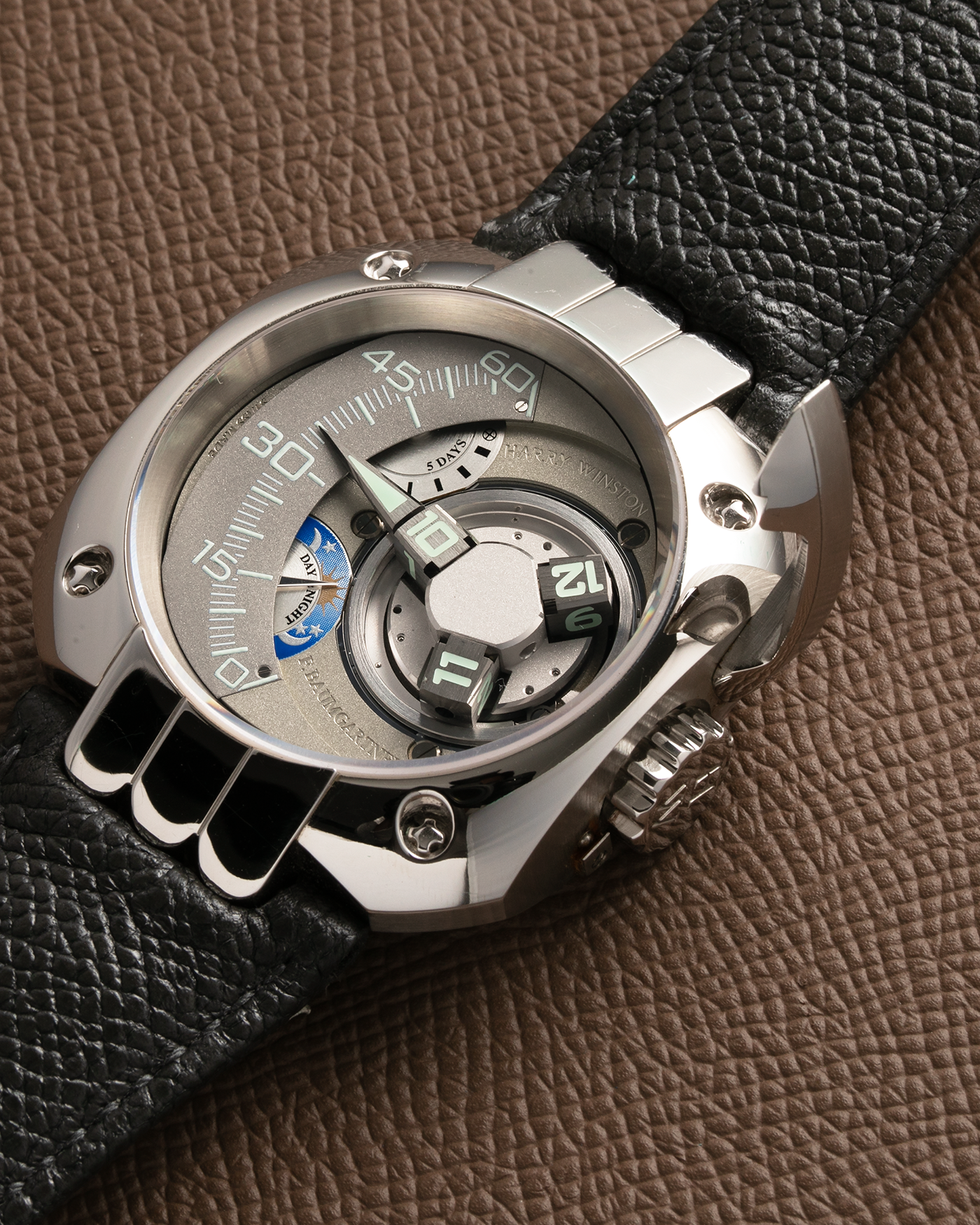 Brand: Harry Winston Year: 2005 Model: Opus V, Limited Edition of 45 pieces in Platinum Material: Platinum 950 Movement: Harry Winston Cal. HW1026 in ARCAP Alloy, Manual-Winding Case Diameter: 50mm Strap: Philips Grey Calf Leather Strap with Signed Platinum Tang Buckle