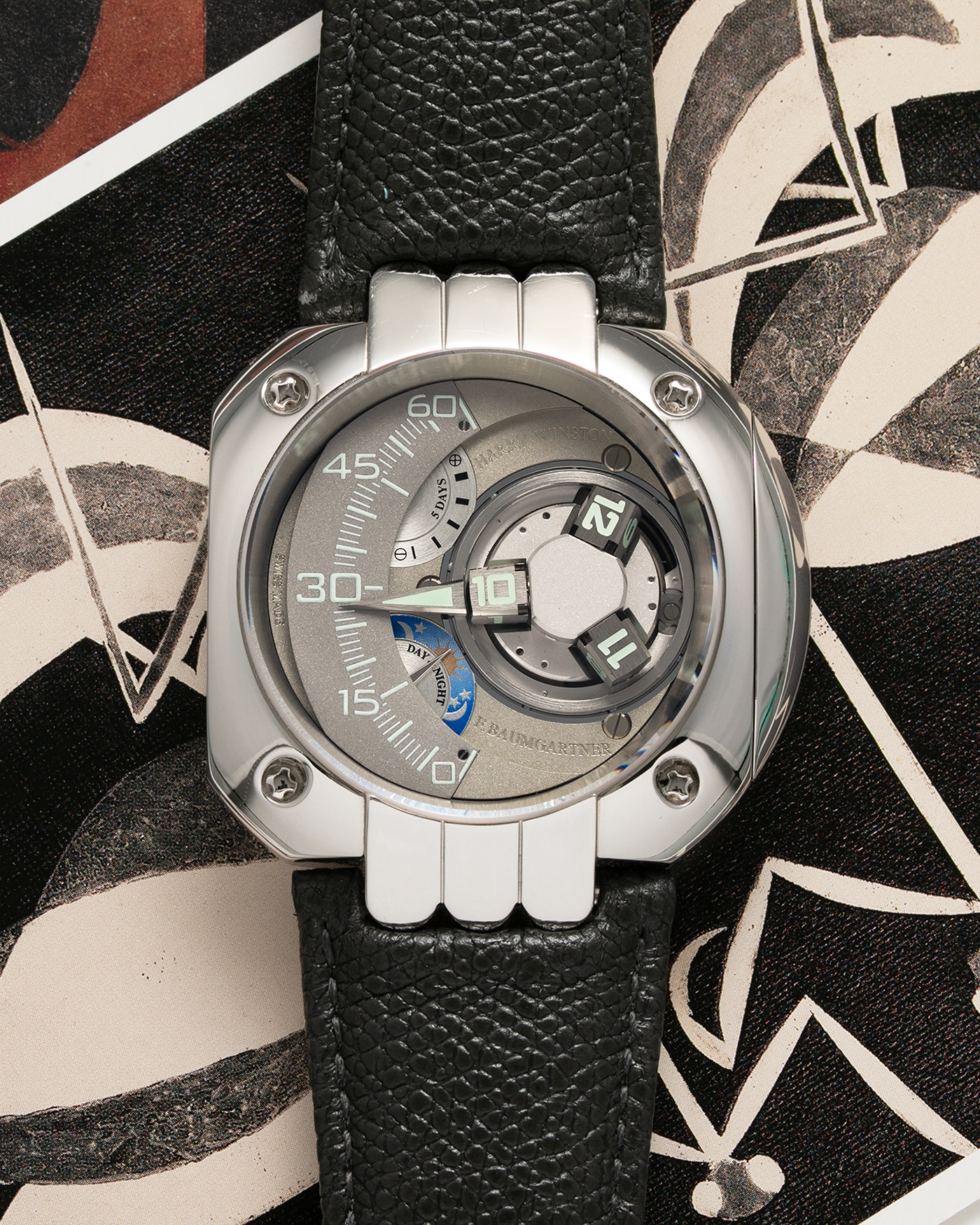 Brand: Harry Winston Year: 2005 Model: Opus V, Limited Edition of 45 pieces in Platinum Material: Platinum 950 Movement: Harry Winston Cal. HW1026 in ARCAP Alloy, Manual-Winding Case Diameter: 50mm Strap: Philips Grey Calf Leather Strap with Signed Platinum Tang Buckle