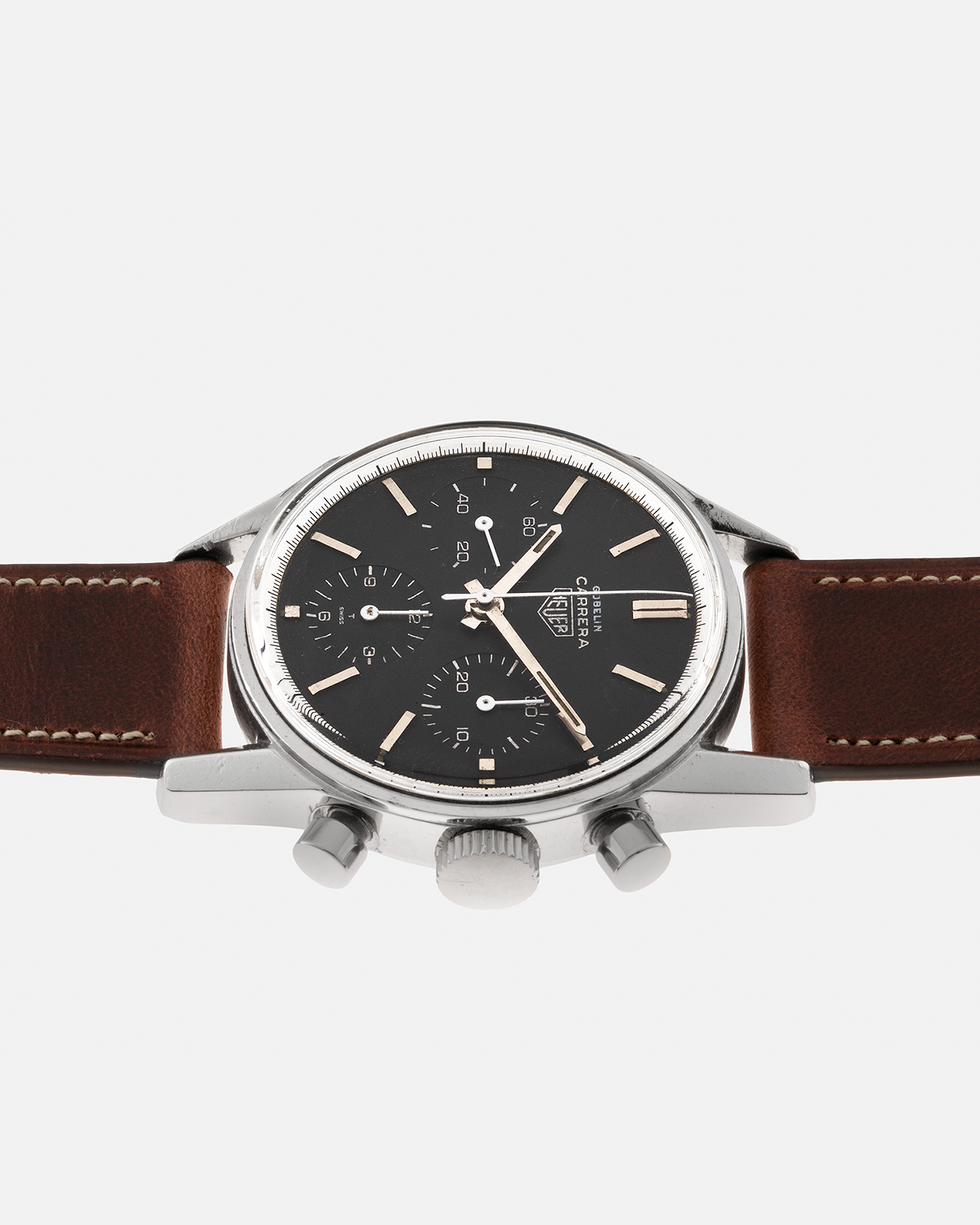 Brand: Heuer Year: 1960’s Model: Carrera Reference Number: 2447N Serial Number: 69XXX Material: Stainless Steel Movement: Valjoux 72 Case Diameter: 36mm Lug Width: 18mm Strap: Nostime Medium Brown Calf Leather Strap with Stainless Steel Tang Buckle