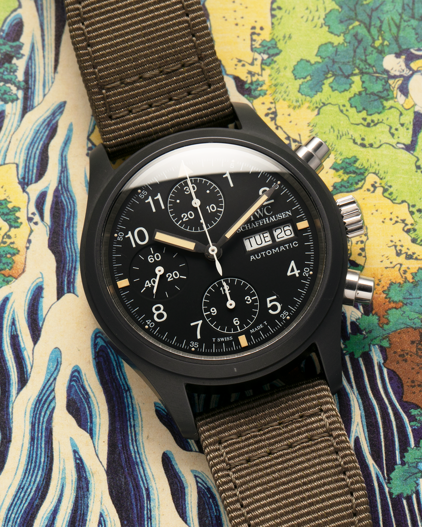 Brand: IWC
Year: Mid-1990s
Model: Fliegerchronograph ‘Keramik’
Reference: 3705
Material: Ceramic and Stainless Steel Case
Movement: Valjoux Cal. 7750 (Modified by IWC), Self-Winding
Case Dimensions: 39mm x 14.8mm (47.7mm Lug-to-Lug)
Lug Width: 20mm
Strap: IWC Army Green Canvas Strap with Signed Stainless Steel Tang Buckle