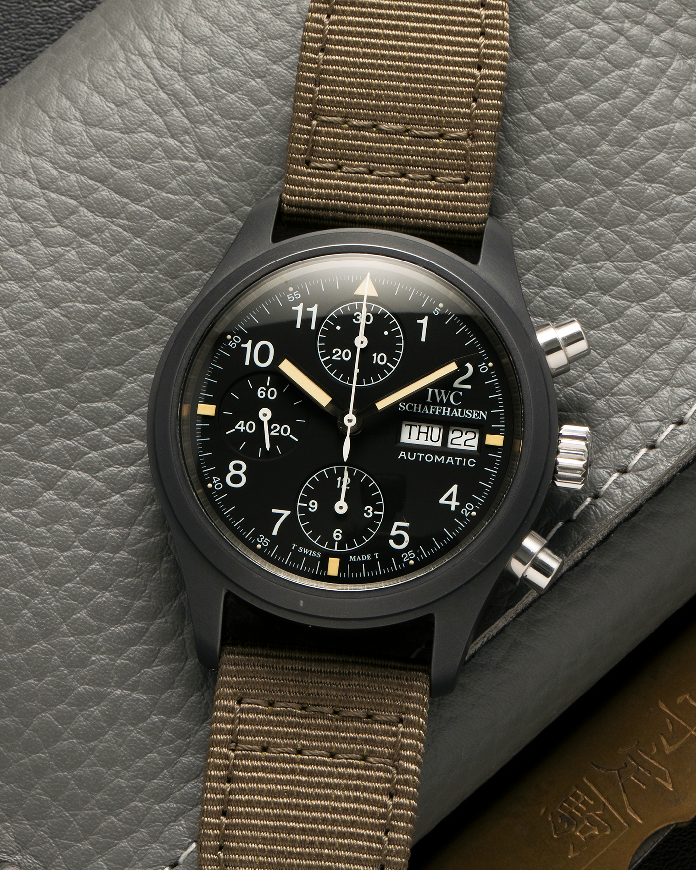 Brand: IWC
Year: Mid-1990s
Model: Fliegerchronograph ‘Keramik’
Reference: 3705
Material: Ceramic and Stainless Steel Case
Movement: Valjoux Cal. 7750 (Modified by IWC), Self-Winding
Case Dimensions: 39mm x 14.8mm (47.7mm Lug-to-Lug)
Lug Width: 20mm
Strap: IWC Army Green Canvas Strap with Signed Stainless Steel Tang Buckle