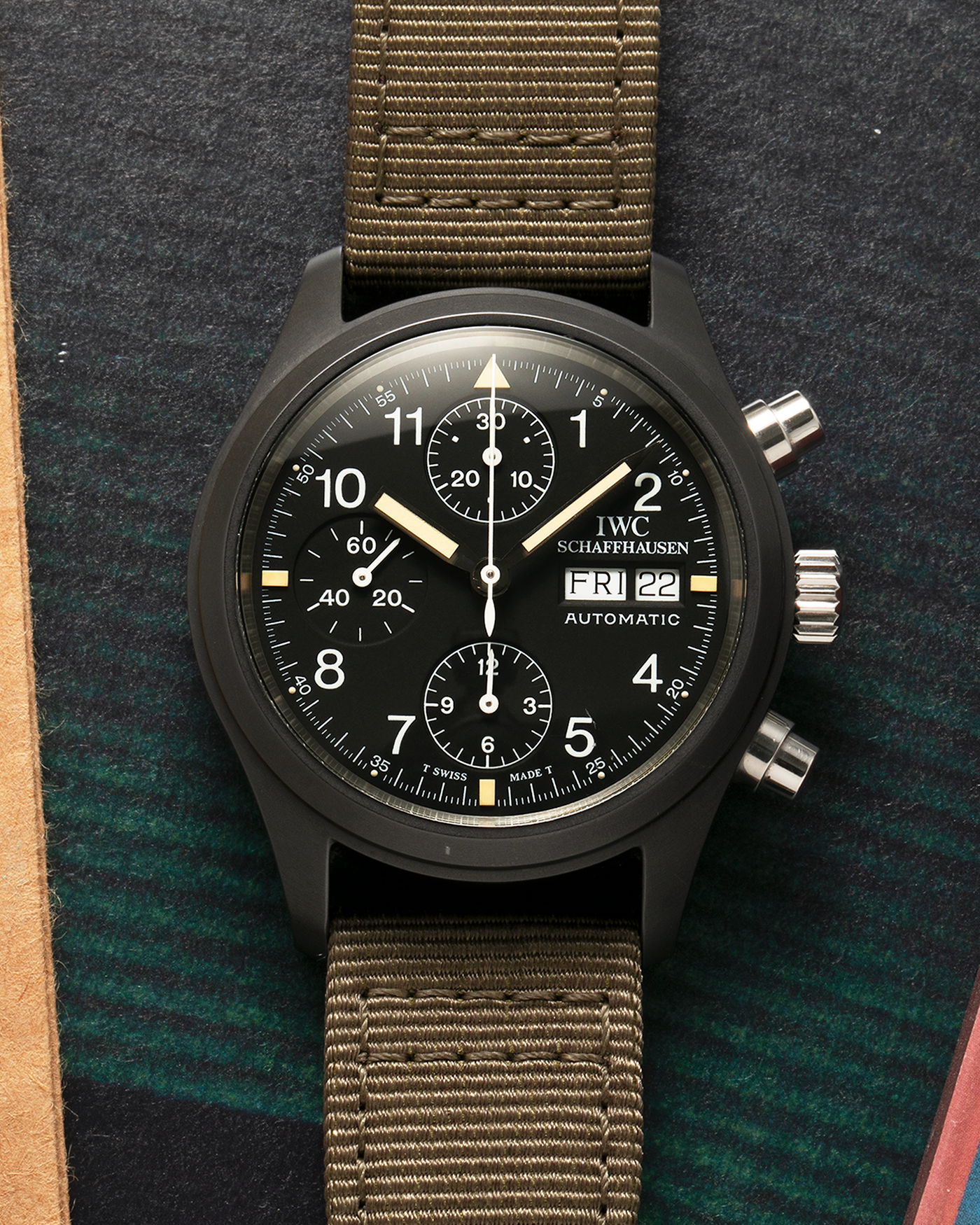 Brand: IWC
Year: Mid-1990s
Model: Fliegerchronograph ‘Keramik’
Reference: 3705
Material: Ceramic and Stainless Steel Case
Movement: Valjoux Cal. 7750 (Modified by IWC), Self-Winding
Case Dimensions: 39mm x 14.8mm (47.7mm Lug-to-Lug)
Lug Width: 20mm
Strap: IWC Army Green Canvas Strap with Signed Stainless Steel Tang Buckle