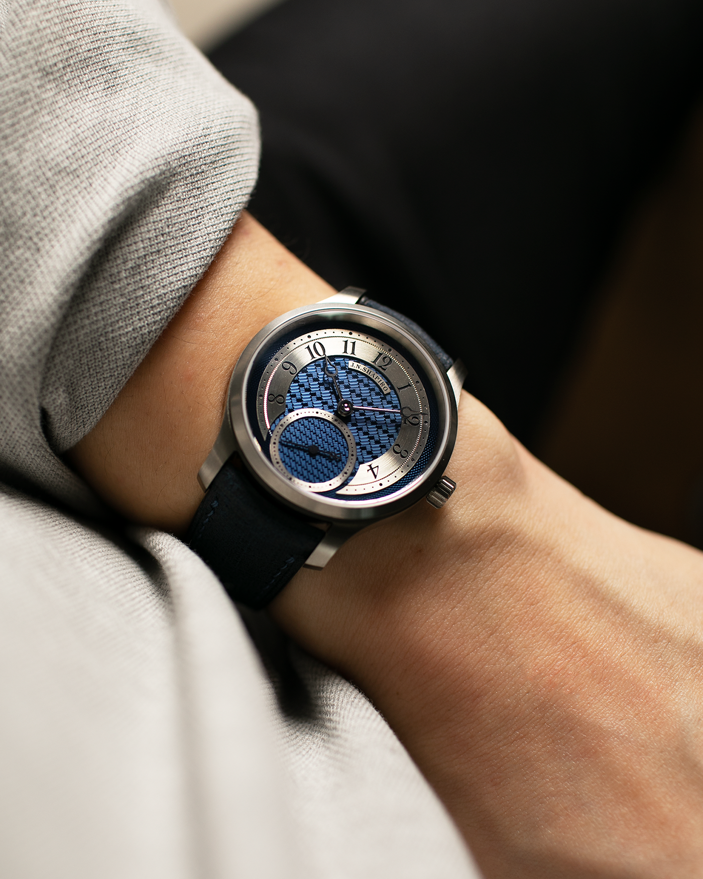 Brand: J.N. Shapiro Year: 2023 Model: Infinity Series Titanium Material: Titanium Case, Silver Dial, White Gold Hands Movement: UWD Cal. 33.1, Manual-Winding Case Dimensions: 39mm x 9.75mm Lug Width: 20mm Strap: J.N. Shapiro by Delugs Navy Blue Leather Strap with Signed Titanium Tang Buckle