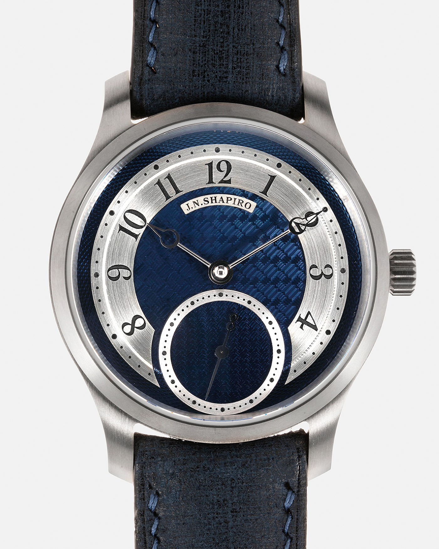 Brand: J.N. Shapiro Year: 2023 Model: Infinity Series Titanium Material: Titanium Case, Silver Dial, White Gold Hands Movement: UWD Cal. 33.1, Manual-Winding Case Dimensions: 39mm x 9.75mm Lug Width: 20mm Strap: J.N. Shapiro by Delugs Navy Blue Leather Strap with Signed Titanium Tang Buckle