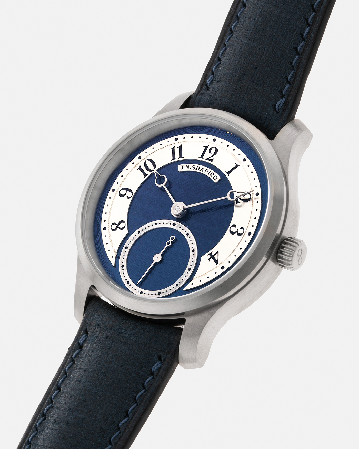 Brand: J.N. Shapiro Year: 2023 Model: Infinity Series Titanium Material: Titanium Case, Silver Dial, White Gold Hands Movement: UWD Cal. 33.1, Manual-Winding Case Dimensions: 39mm x 9.75mm Lug Width: 20mm Strap: J.N. Shapiro by Delugs Navy Blue Leather Strap with Signed Titanium Tang Buckle