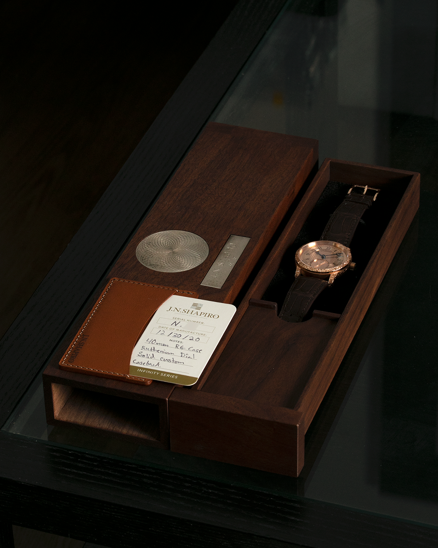 Brand: J.N. Shapiro Year: 2020 Model: Infinity Series (Piece Unique) Material: 18-carat Rose Gold Case, Ruthenium Dial Movement: UWD Cal. 33.1, Manual-Winding Case Diameter: 40mm Lug Width: 22mm Strap: J.N. Shapiro Dark Brown Alligator Strap with Custom Engraved 18-carat Rose Gold Tang Buckle