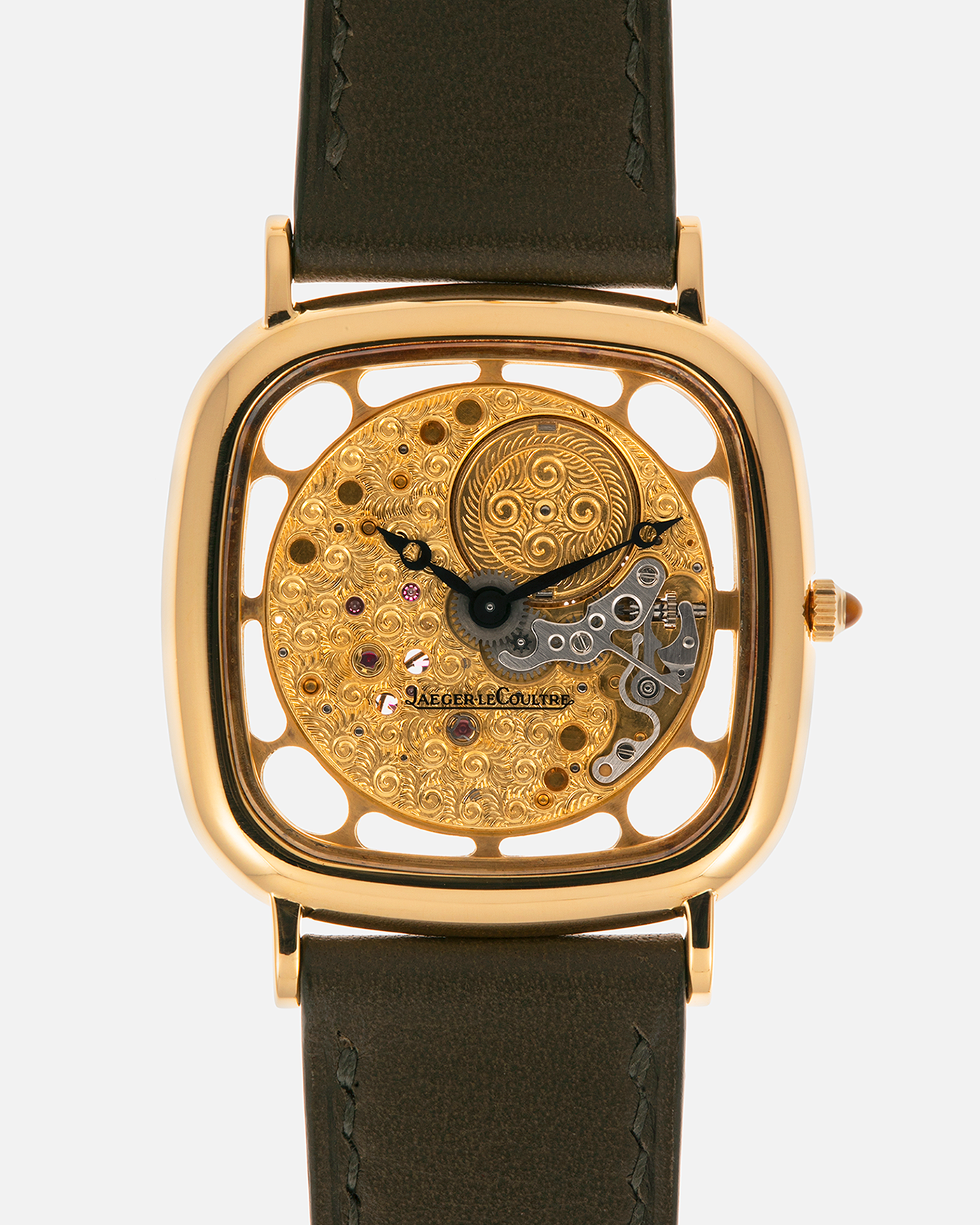 Brand: Jaeger-LeCoultre
Reference: 141.007.1 Skeleton
Year: 1981
Material: 18-carat Yellow Gold Case, 14-Carat Yellow Gold Movement, Tiger Eye Cabochon
Movement: Jaeger-LeCoultre Cal. 839, Skeletonized and Manual-Winding
Case Dimensions: 33mm x 4.9mm (Lug-to-Lug 38mm)
Lug Width: 18mm
Strap: Custom Olive Green Calf Leather Strap with Mustard-Yellow Underlining