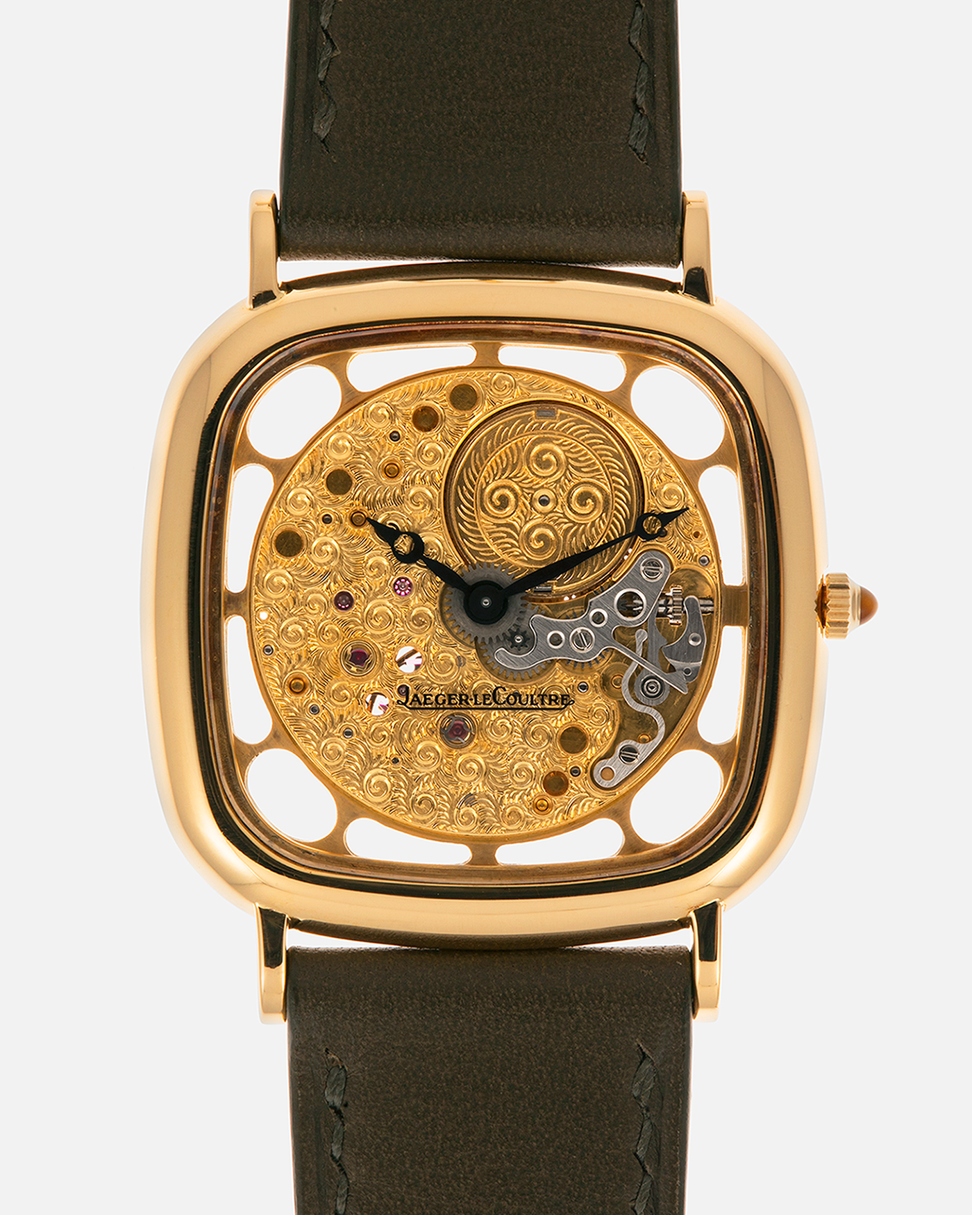Brand: Jaeger-LeCoultre
Reference: 141.007.1 Skeleton
Year: 1981
Material: 18-carat Yellow Gold Case, 14-Carat Yellow Gold Movement, Tiger Eye Cabochon
Movement: Jaeger-LeCoultre Cal. 839, Skeletonized and Manual-Winding
Case Dimensions: 33mm x 4.9mm (Lug-to-Lug 38mm)
Lug Width: 18mm
Strap: Custom Olive Green Calf Leather Strap with Mustard-Yellow Underlining