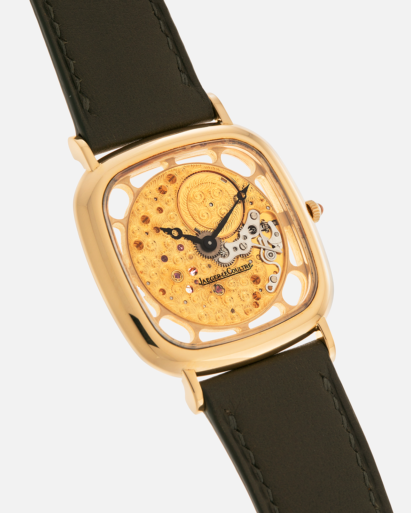 Brand: Jaeger-LeCoultre
Reference: 141.007.1 Skeleton
Year: 1981
Material: 18-carat Yellow Gold Case, 14-Carat Yellow Gold Movement, Tiger Eye Cabochon
Movement: Jaeger-LeCoultre Cal. 839, Skeletonized and Manual-Winding
Case Dimensions: 33mm x 4.9mm (Lug-to-Lug 38mm)
Lug Width: 18mm
Strap: Custom Olive Green Calf Leather Strap with Mustard-Yellow Underlining