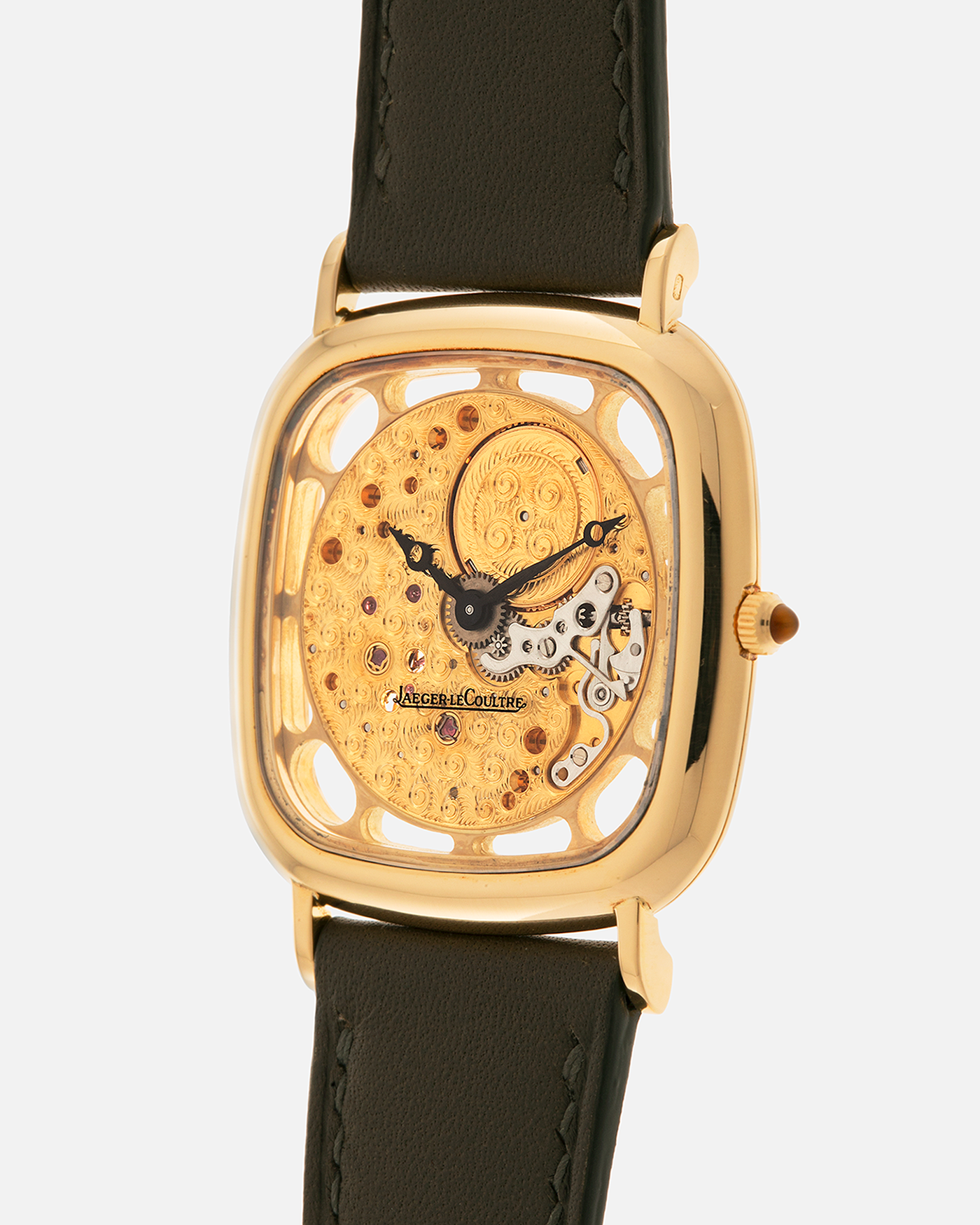 Brand: Jaeger-LeCoultre
Reference: 141.007.1 Skeleton
Year: 1981
Material: 18-carat Yellow Gold Case, 14-Carat Yellow Gold Movement, Tiger Eye Cabochon
Movement: Jaeger-LeCoultre Cal. 839, Skeletonized and Manual-Winding
Case Dimensions: 33mm x 4.9mm (Lug-to-Lug 38mm)
Lug Width: 18mm
Strap: Custom Olive Green Calf Leather Strap with Mustard-Yellow Underlining