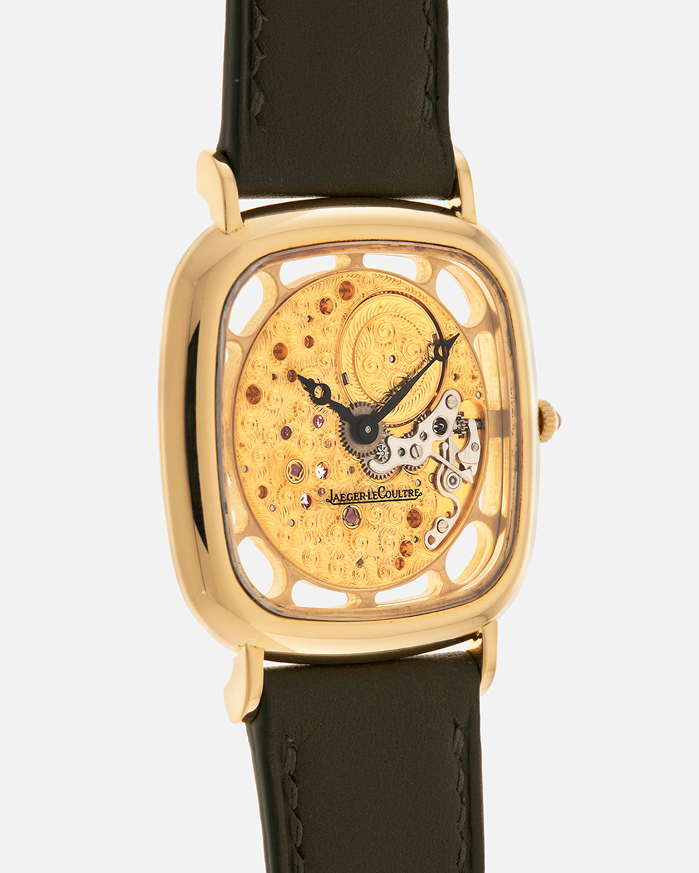 Brand: Jaeger-LeCoultre
Reference: 141.007.1 Skeleton
Year: 1981
Material: 18-carat Yellow Gold Case, 14-Carat Yellow Gold Movement, Tiger Eye Cabochon
Movement: Jaeger-LeCoultre Cal. 839, Skeletonized and Manual-Winding
Case Dimensions: 33mm x 4.9mm (Lug-to-Lug 38mm)
Lug Width: 18mm
Strap: Custom Olive Green Calf Leather Strap with Mustard-Yellow Underlining