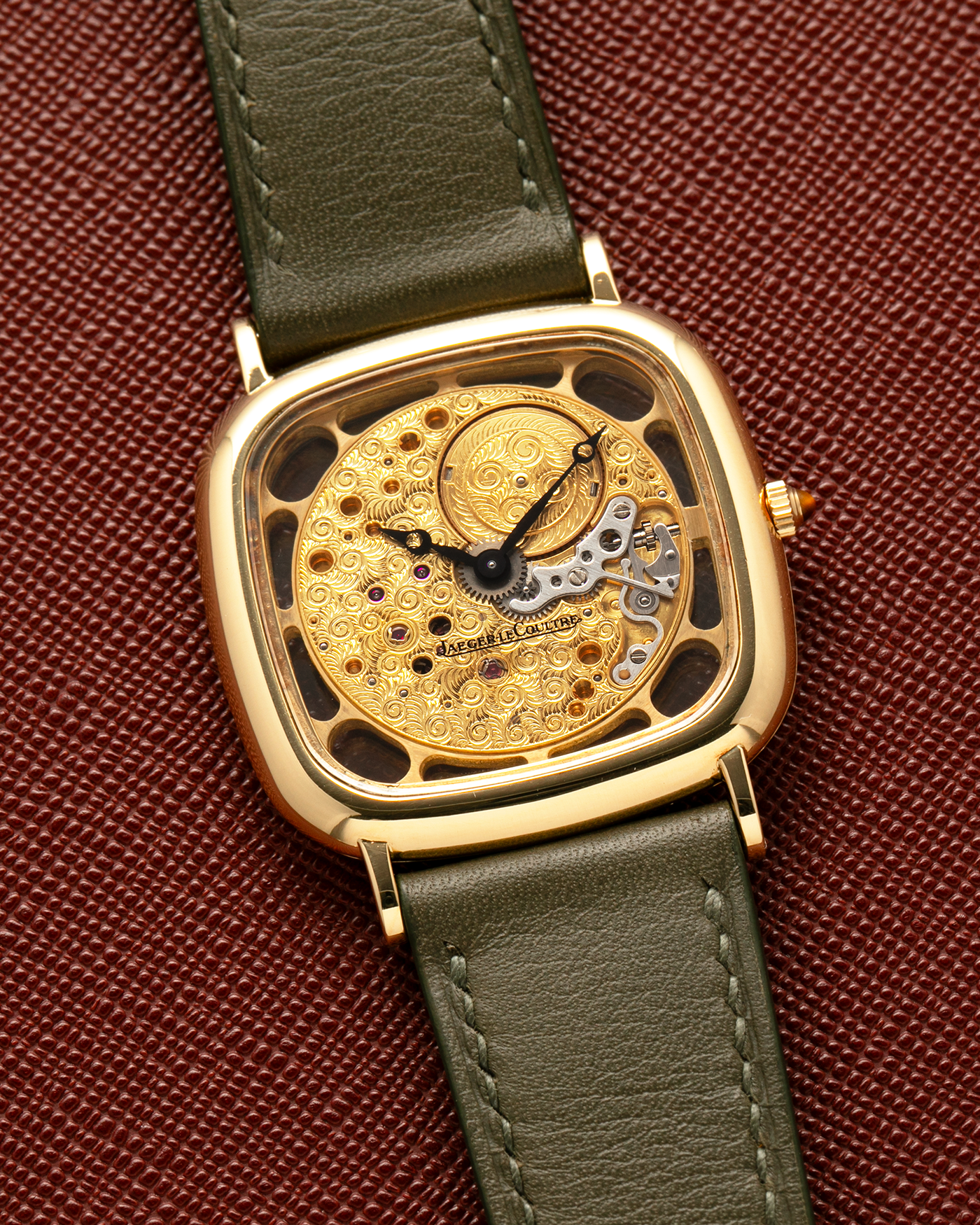 Brand: Jaeger-LeCoultre
Reference: 141.007.1 Skeleton
Year: 1981
Material: 18-carat Yellow Gold Case, 14-Carat Yellow Gold Movement, Tiger Eye Cabochon
Movement: Jaeger-LeCoultre Cal. 839, Skeletonized and Manual-Winding
Case Dimensions: 33mm x 4.9mm (Lug-to-Lug 38mm)
Lug Width: 18mm
Strap: Custom Olive Green Calf Leather Strap with Mustard-Yellow Underlining