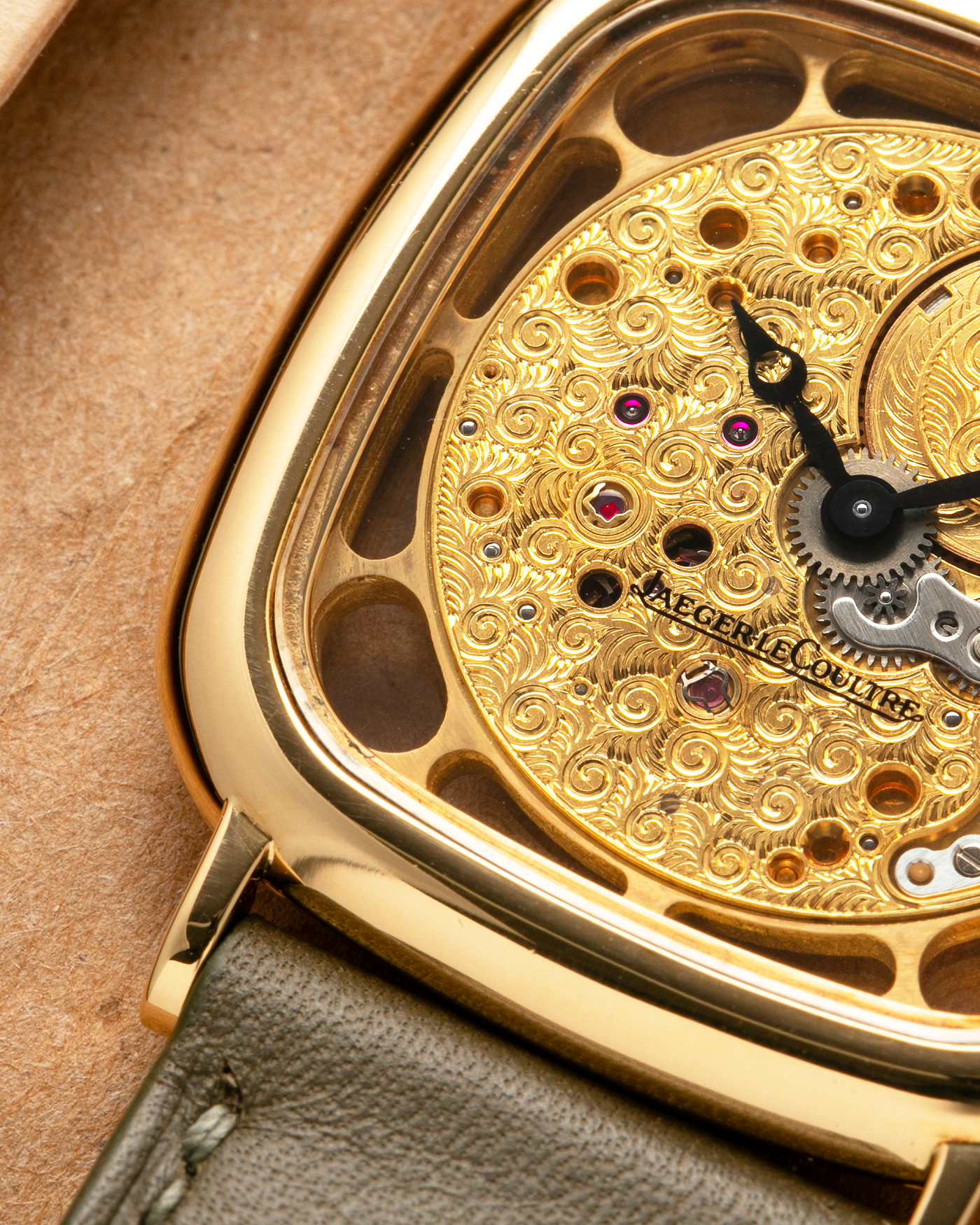 Brand: Jaeger-LeCoultre
Reference: 141.007.1 Skeleton
Year: 1981
Material: 18-carat Yellow Gold Case, 14-Carat Yellow Gold Movement, Tiger Eye Cabochon
Movement: Jaeger-LeCoultre Cal. 839, Skeletonized and Manual-Winding
Case Dimensions: 33mm x 4.9mm (Lug-to-Lug 38mm)
Lug Width: 18mm
Strap: Custom Olive Green Calf Leather Strap with Mustard-Yellow Underlining