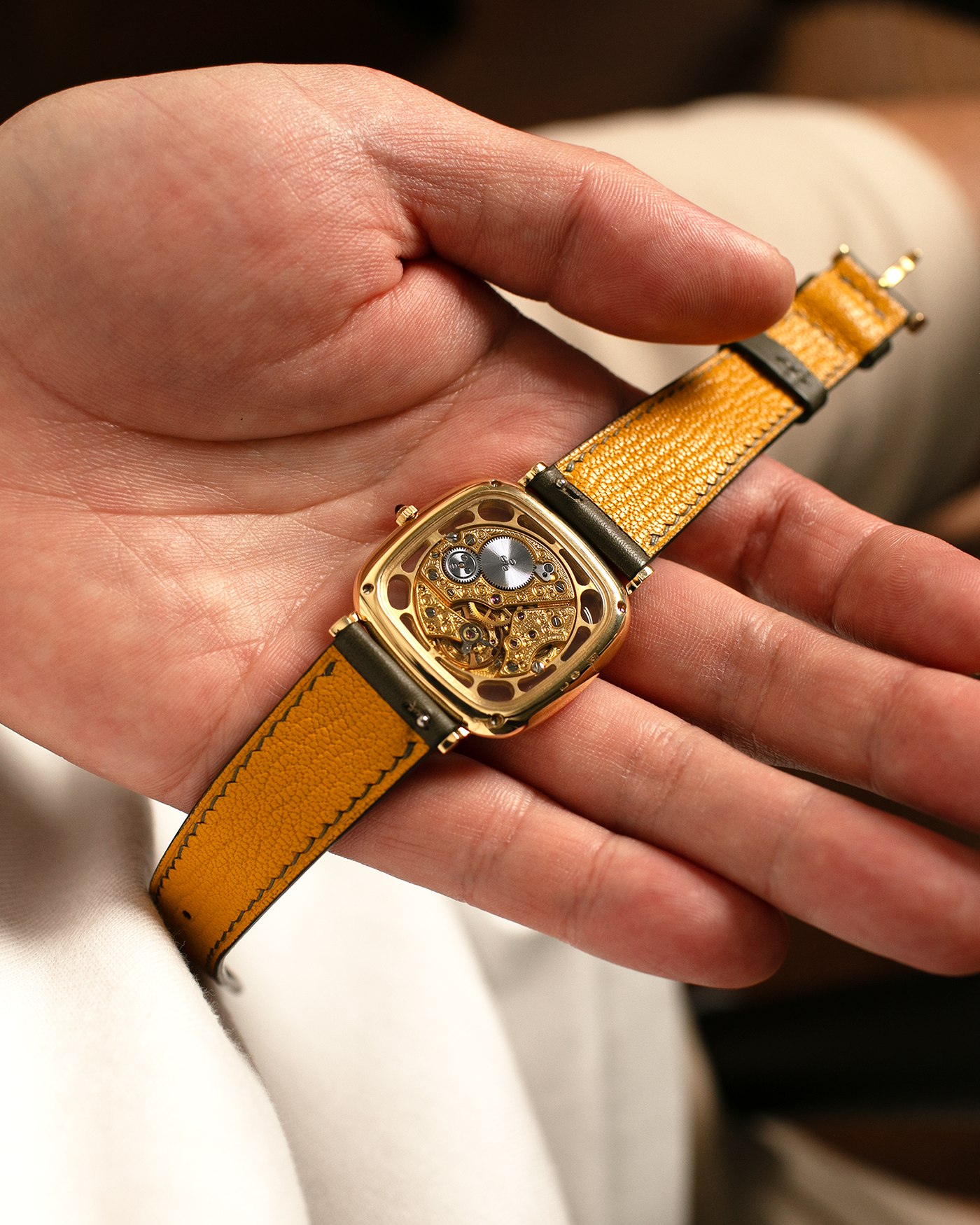 Brand: Jaeger-LeCoultre
Reference: 141.007.1 Skeleton
Year: 1981
Material: 18-carat Yellow Gold Case, 14-Carat Yellow Gold Movement, Tiger Eye Cabochon
Movement: Jaeger-LeCoultre Cal. 839, Skeletonized and Manual-Winding
Case Dimensions: 33mm x 4.9mm (Lug-to-Lug 38mm)
Lug Width: 18mm
Strap: Custom Olive Green Calf Leather Strap with Mustard-Yellow Underlining