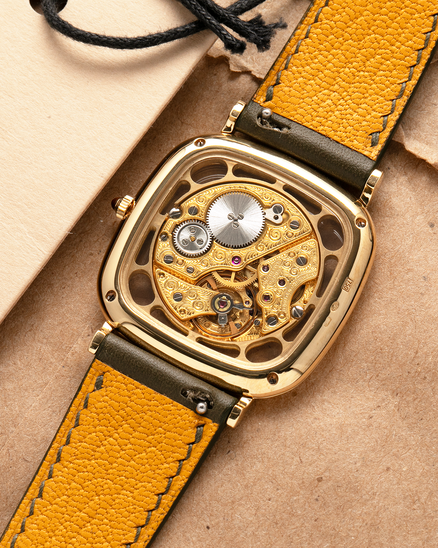 Brand: Jaeger-LeCoultre
Reference: 141.007.1 Skeleton
Year: 1981
Material: 18-carat Yellow Gold Case, 14-Carat Yellow Gold Movement, Tiger Eye Cabochon
Movement: Jaeger-LeCoultre Cal. 839, Skeletonized and Manual-Winding
Case Dimensions: 33mm x 4.9mm (Lug-to-Lug 38mm)
Lug Width: 18mm
Strap: Custom Olive Green Calf Leather Strap with Mustard-Yellow Underlining