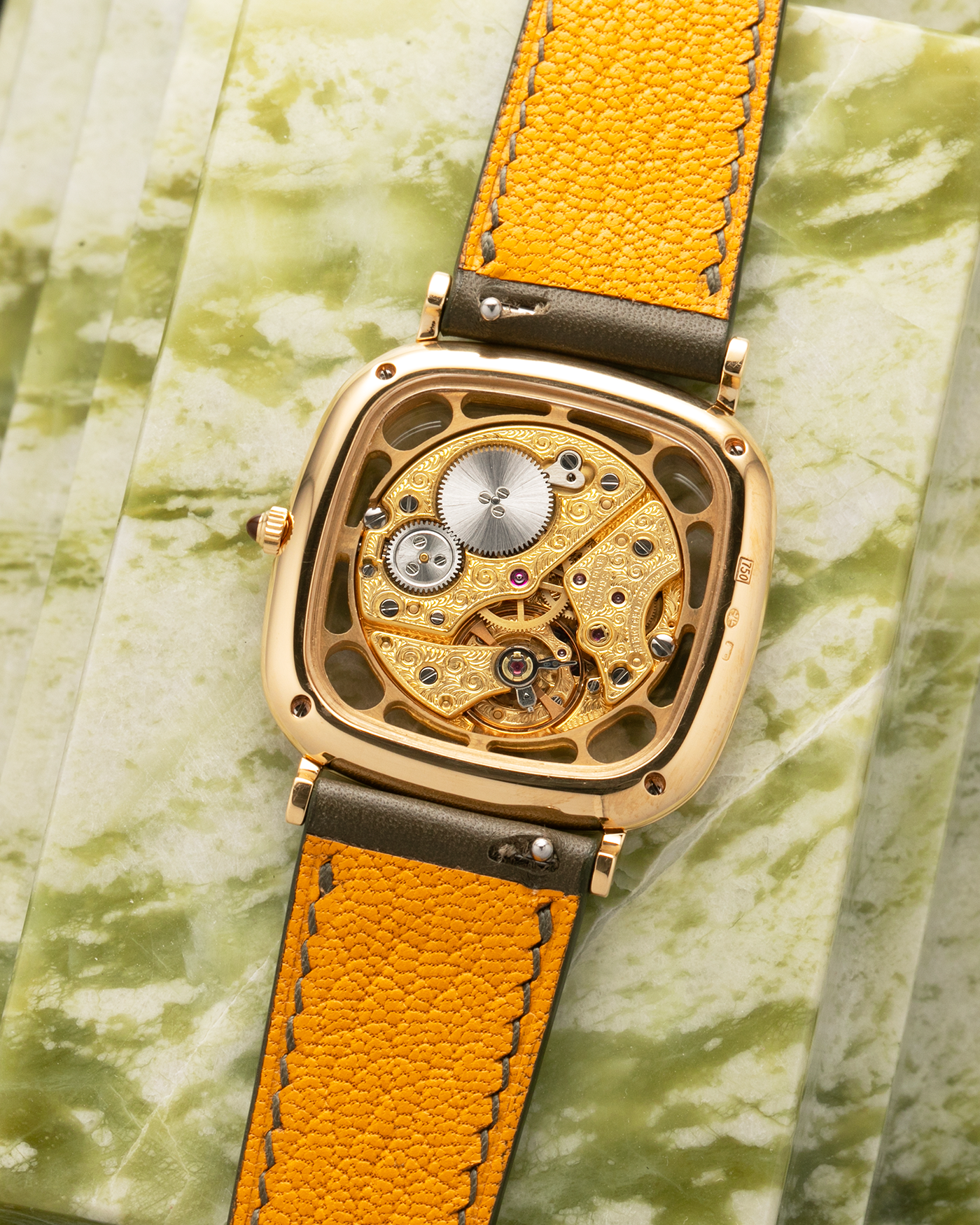 Brand: Jaeger-LeCoultre
Reference: 141.007.1 Skeleton
Year: 1981
Material: 18-carat Yellow Gold Case, 14-Carat Yellow Gold Movement, Tiger Eye Cabochon
Movement: Jaeger-LeCoultre Cal. 839, Skeletonized and Manual-Winding
Case Dimensions: 33mm x 4.9mm (Lug-to-Lug 38mm)
Lug Width: 18mm
Strap: Custom Olive Green Calf Leather Strap with Mustard-Yellow Underlining