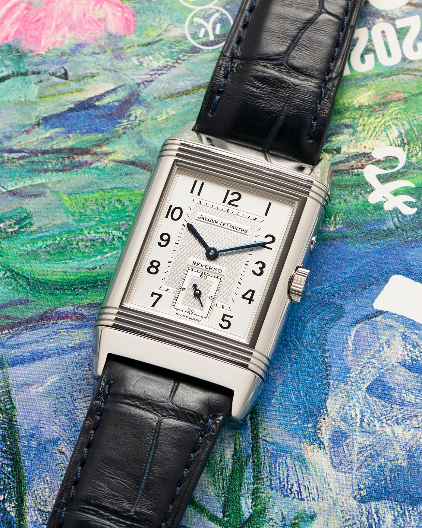 Brand: Jaeger LeCoultre
Year: Late 1990s
Model: Reverso Duoface Japan Edition Blue, Limited Edition of 300 Pieces
Reference Number: 270.8.54
Material: Stainless Steel
Movement: Jaeger LeCoultre Cal. 854, Manual-Wind
Case Dimensions: 42mm (Including Lugs) x 26mm
Lug Width: 19mm
Strap: Jaeger LeCoultre Black Alligator Leather Strap with Signed Stainless Steel Deployant Clasp