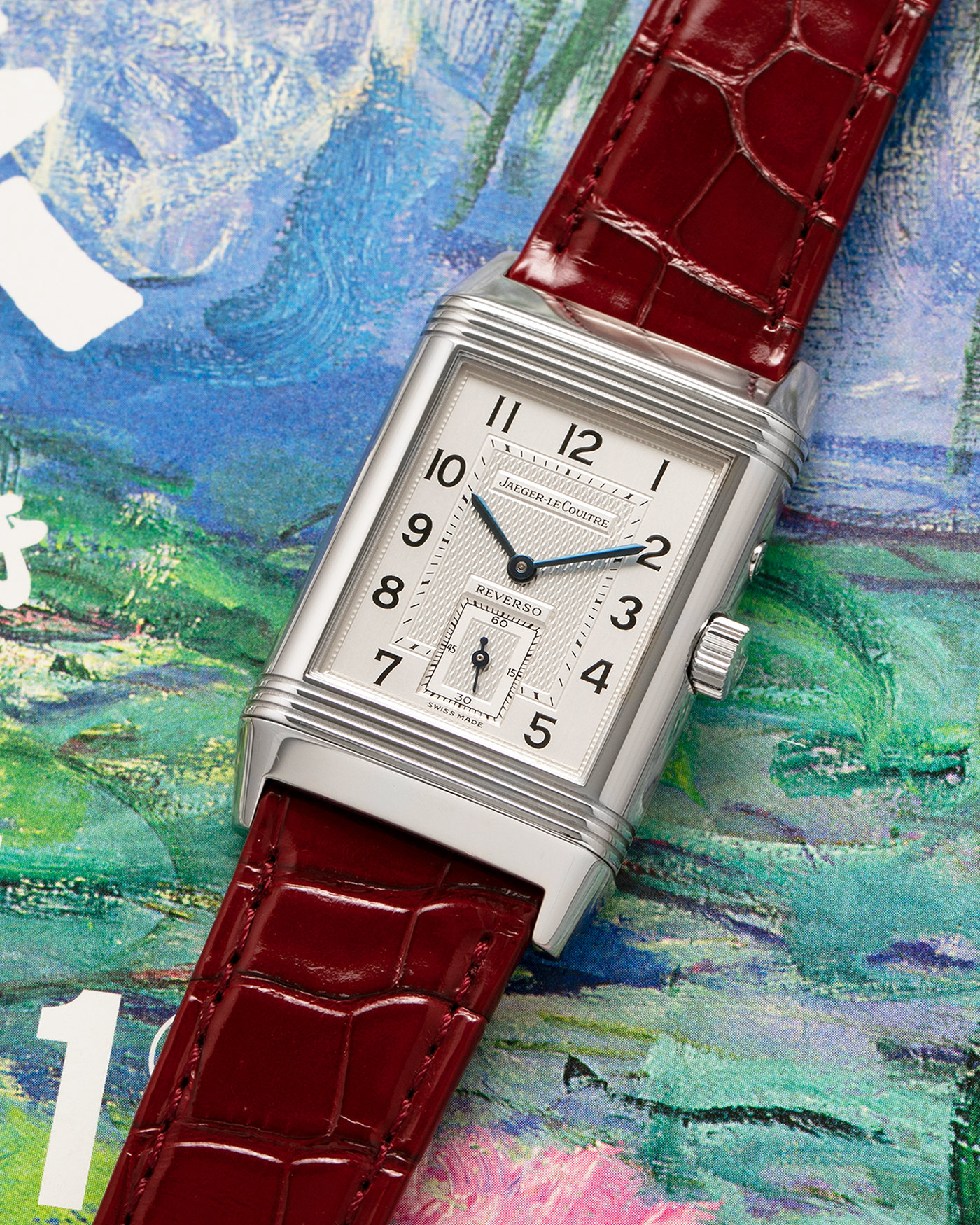Brand: Jaeger LeCoultre
Year: Late 1990s
Model: Reverso Duoface Japan Edition Red, Limited Edition of 300 Pieces
Reference Number: 270.8.54
Material: Stainless Steel
Movement: Jaeger LeCoultre Cal. 854, Manual-Wind
Case Dimensions: 42mm (Including Lugs) x 26mm
Lug Width: 19mm
Strap: Jaeger LeCoultre Burgundy Red Alligator Leather Strap with Signed Stainless Steel Deployant Clasp