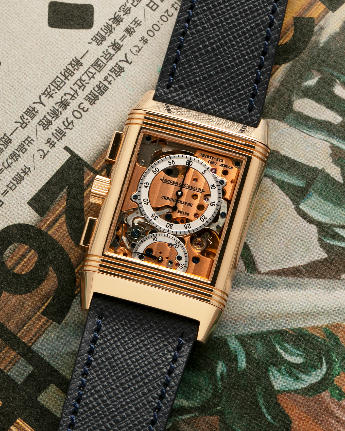 Brand: Jaeger LeCoultre Year: 1996 Model: Reverso Chronographe Retrograde, Limited to 500 pieces Reference: 270.2.69 Material: 18-carat Rose Gold Movement: Jaeger LeCoultre Cal. 829, Manual-Wind Case Dimensions: 42mm x 26mm x 9.5mm Lug Width: 19mm Strap: Molequin Navy Blue Textured Calf with Signed 18-carat Rose Gold Deployant Clasp