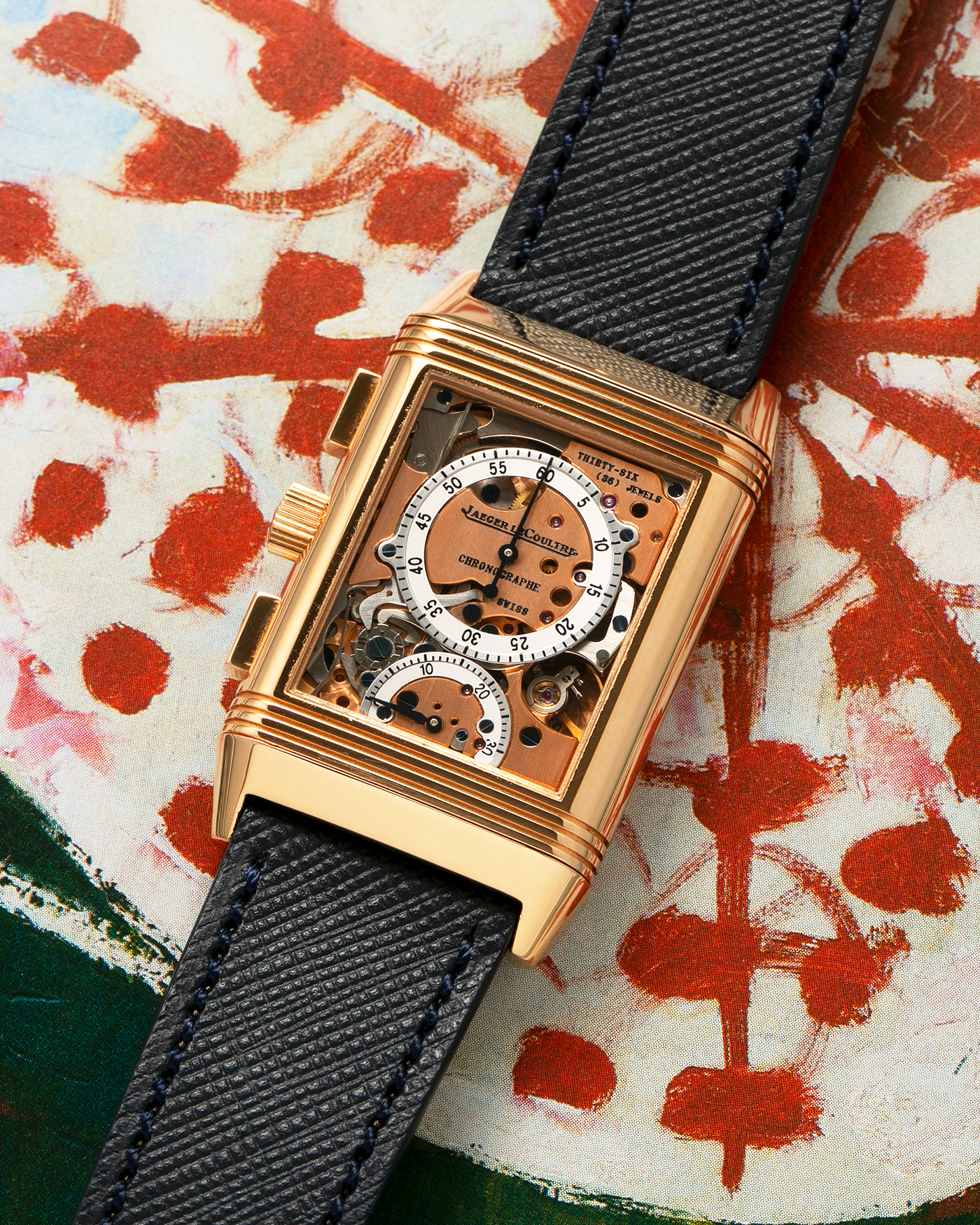 Brand: Jaeger LeCoultre Year: 1996 Model: Reverso Chronographe Retrograde, Limited to 500 pieces Reference: 270.2.69 Material: 18-carat Rose Gold Movement: Jaeger LeCoultre Cal. 829, Manual-Wind Case Dimensions: 42mm x 26mm x 9.5mm Lug Width: 19mm Strap: Molequin Navy Blue Textured Calf with Signed 18-carat Rose Gold Deployant Clasp