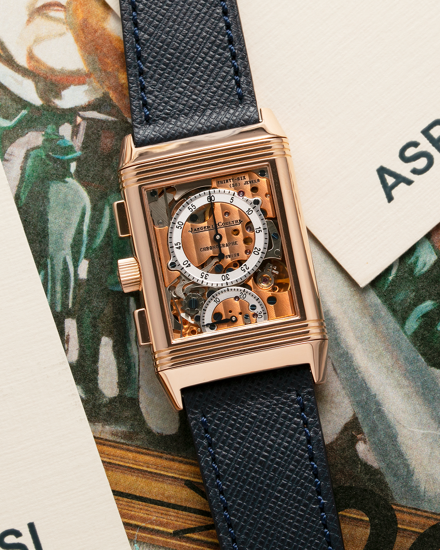 Brand: Jaeger LeCoultre Year: 1996 Model: Reverso Chronographe Retrograde, Limited to 500 pieces Reference: 270.2.69 Material: 18-carat Rose Gold Movement: JLC Cal. 829, Manual-Wind Case Diameter: 42mm x 26mm x 9.5mm Strap: Molequin Navy Blue Textured Calf with Signed 18-carat Rose Gold Deployant Clasp