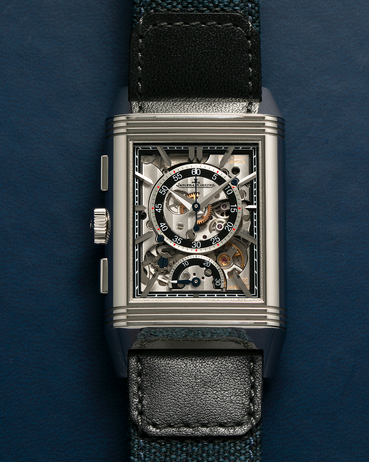 Brand: Jaeger LeCoultre
Year: 2024
Model: Q389848J, Reverso Tribute Chronograph
Reference Number: 216.8.S0
Material: Stainless Steel
Movement: Jaeger LeCoultre Cal. 860, Manual-Winding
Case Diameter:  49.9mm (Including Lugs) x 29.9mm x 11.14mm
Lug Width: 20mm
Straps: Jaeger LeCoultre Casa Fagliano Calf Leather Strap with Signed Stainless Steel Deployant Clasp, with extra  Jaeger LeCoultre Blue Canvas Strap