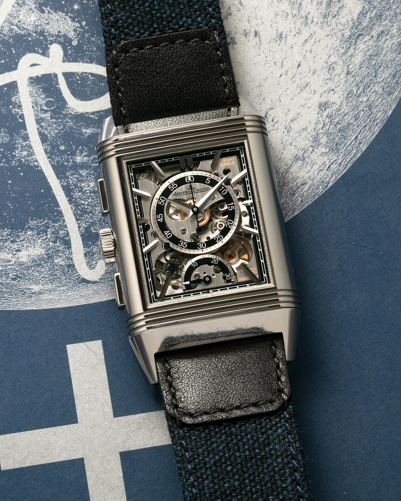 Brand: Jaeger LeCoultre
Year: 2024
Model: Q389848J, Reverso Tribute Chronograph
Reference Number: 216.8.S0
Material: Stainless Steel
Movement: Jaeger LeCoultre Cal. 860, Manual-Winding
Case Diameter:  49.9mm (Including Lugs) x 29.9mm x 11.14mm
Lug Width: 20mm
Straps: Jaeger LeCoultre Casa Fagliano Calf Leather Strap with Signed Stainless Steel Deployant Clasp, with extra  Jaeger LeCoultre Blue Canvas Strap
