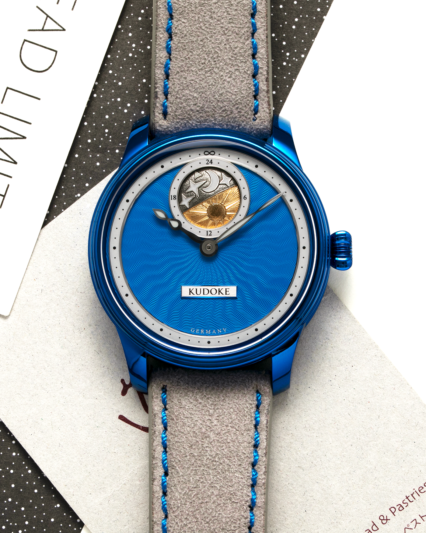 Brand: Kudoke Year: 2022 Model: Kudoke 2 ‘Starry Night’ Grail Watch 8, Limited Edition of 30 pieces Material: Grade 5 Titanium with CVD Blue Finish Movement: In-house Kaliber 1-24H, Manual-Winding Case Diameter: 39mm Strap: Grey Alcantara with Bovine Calf Lining and Blue Stitching with Signed CVD Blue Grade 5 Titanium Tang Buckle, Additional Delugs Navy CTS Rubber Strap, and Delugs Denim Bable Signature Strap