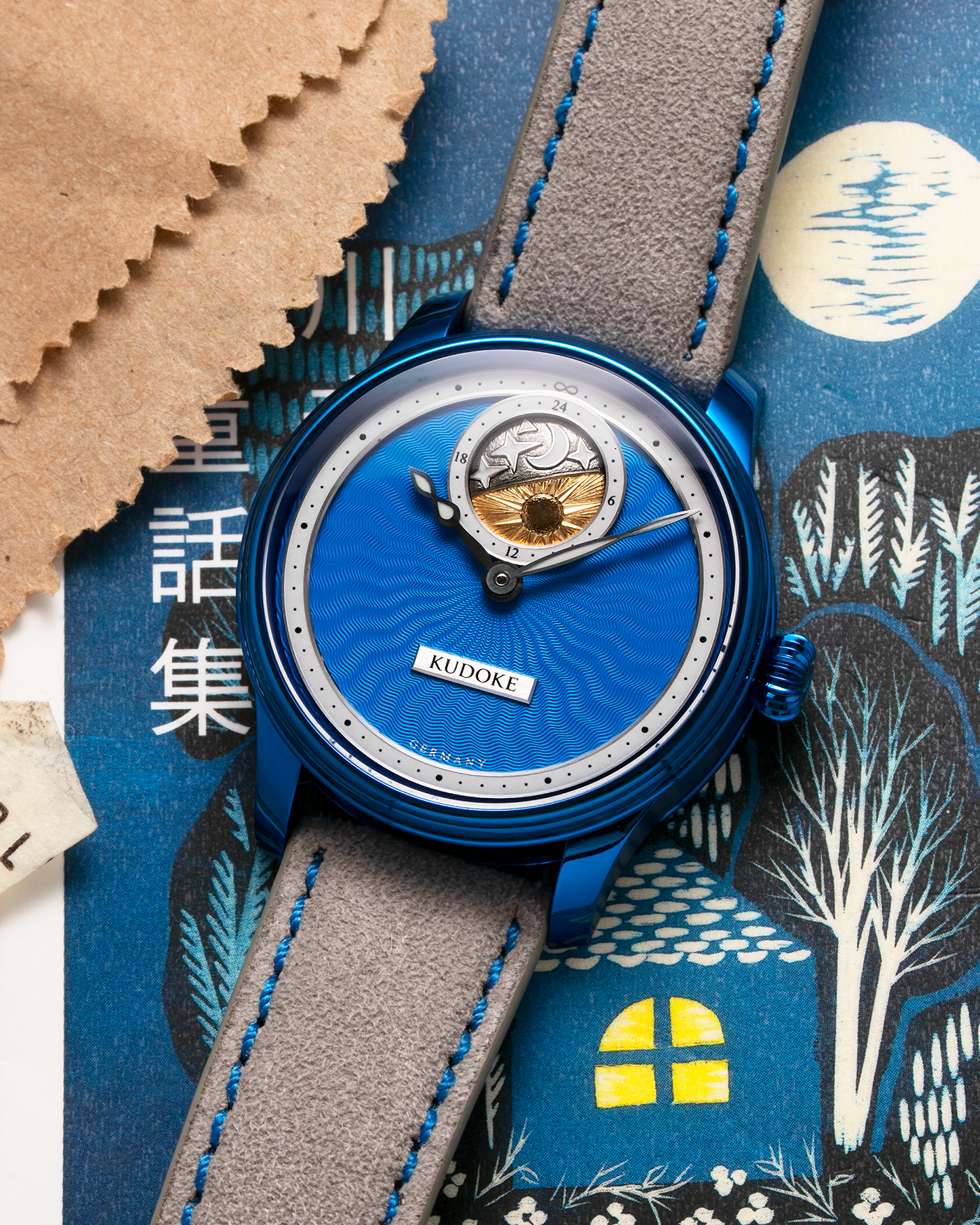 Brand: Kudoke Year: 2022 Model: Kudoke 2 ‘Starry Night’ Grail Watch 8, Limited Edition of 30 pieces Material: Grade 5 Titanium with CVD Blue Finish Movement: In-house Kaliber 1-24H, Manual-Winding Case Diameter: 39mm Strap: Grey Alcantara with Bovine Calf Lining and Blue Stitching with Signed CVD Blue Grade 5 Titanium Tang Buckle, Additional Delugs Navy CTS Rubber Strap, and Delugs Denim Bable Signature Strap