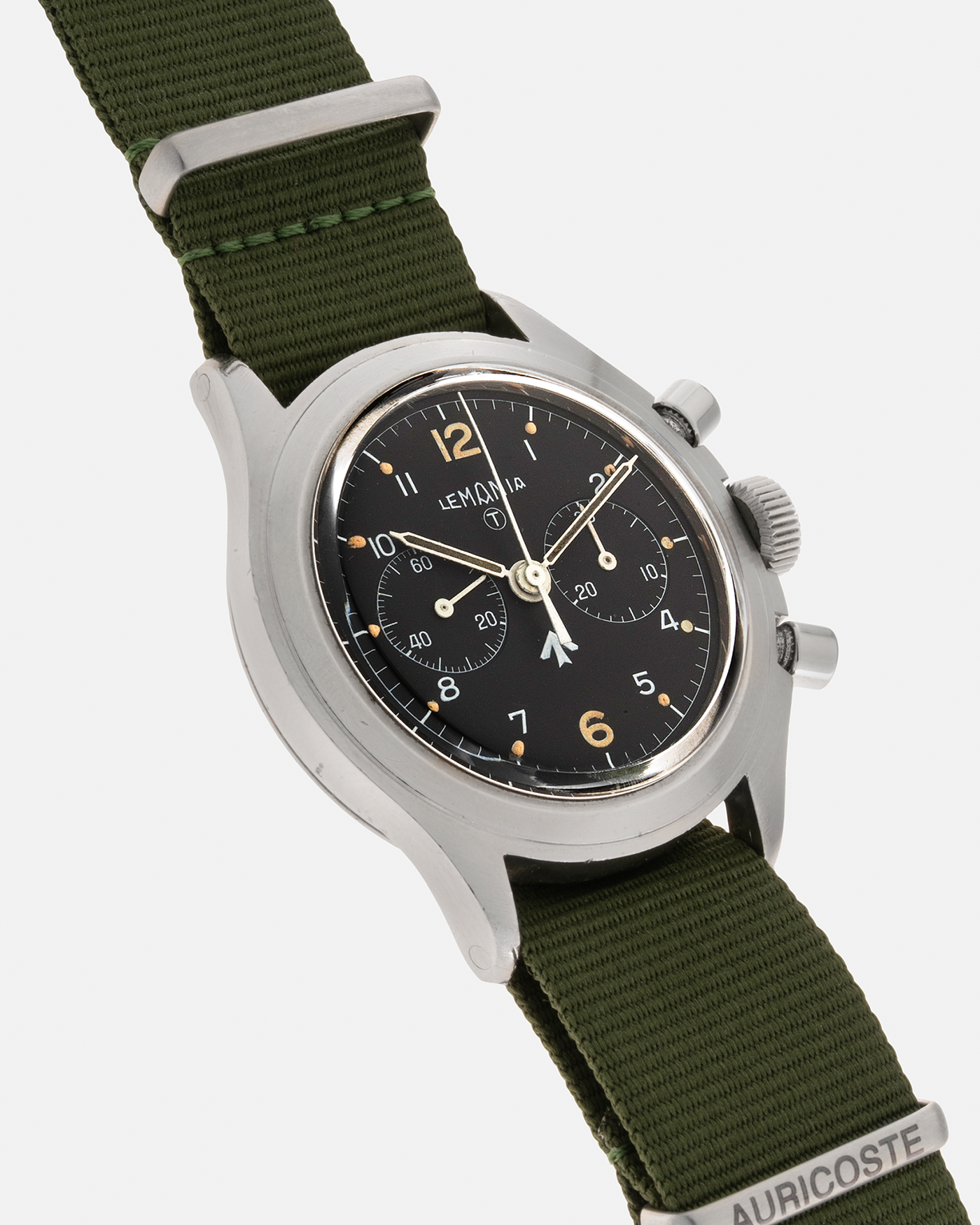 Brand: Lemania Year: 1975 Model: ‘Double Pusher’ Royal Navy Chronograph, Estimated 500 pieces only Reference Number: 818 Material: Stainless Steel Movement: Lemania 2220, Manual-Winding Case Diameter: 40mm Lug Width: 20mm Strap: Auricoste Military Green NATO Strap