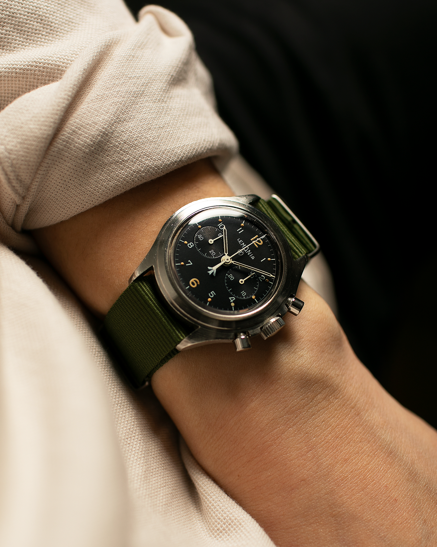 Brand: Lemania Year: 1975 Model: ‘Double Pusher’ Royal Navy Chronograph, Estimated 500 pieces only Reference Number: 818 Material: Stainless Steel Movement: Lemania 2220, Manual-Winding Case Diameter: 40mm Lug Width: 20mm Strap: Auricoste Military Green NATO Strap