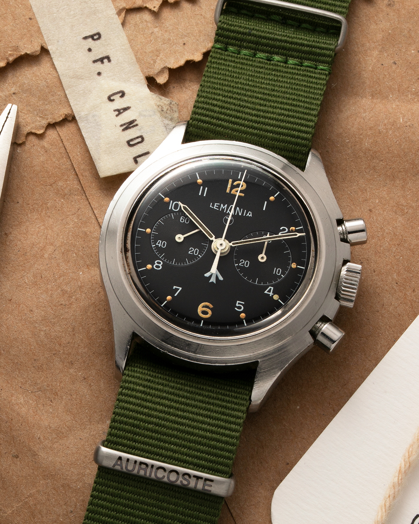 Brand: Lemania Year: 1975 Model: ‘Double Pusher’ Royal Navy Chronograph, Estimated 500 pieces only Reference Number: 818 Material: Stainless Steel Movement: Lemania 2220, Manual-Winding Case Diameter: 40mm Lug Width: 20mm Strap: Auricoste Military Green NATO Strap