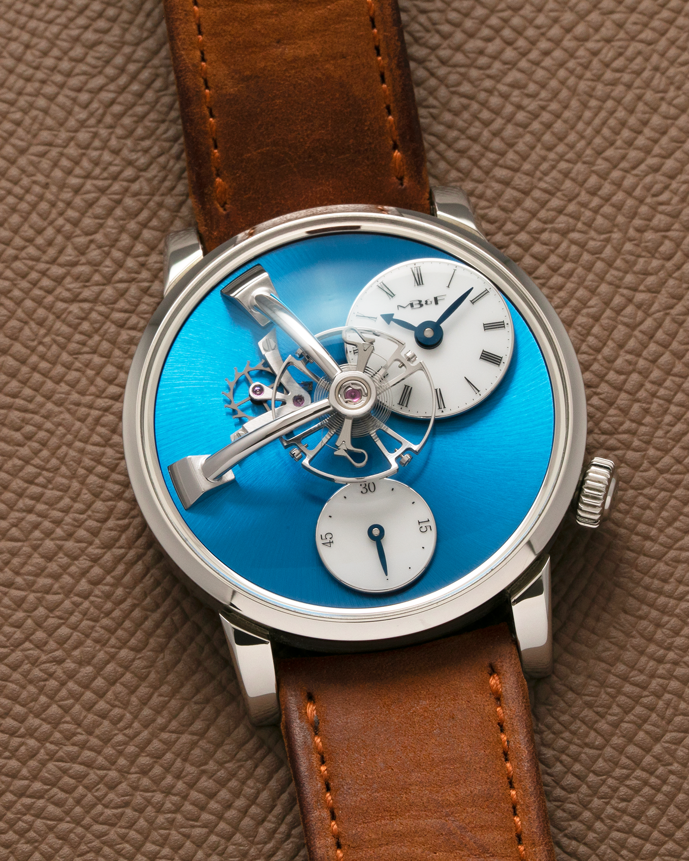 Brand: MB&F Year: 2022 Model: LM101 Steel Blue Material: Stainless Steel with Blue Baseplate Movement: In-House 3-Dimensional MB&F Caliber in Collaboration with Kari Voutilainen, Manual-Winding Case Diameter: 40mm Bracelet/Strap: MB&F Brown Suede Strap and Signed Palladium Deployant Clasp