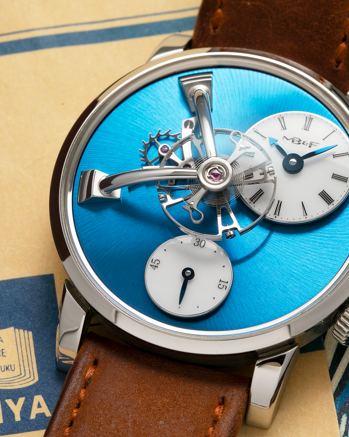 Brand: MB&F Year: 2022 Model: LM101 Steel Blue Material: Stainless Steel with Blue Baseplate Movement: In-House 3-Dimensional MB&F Caliber in Collaboration with Kari Voutilainen, Manual-Winding Case Diameter: 40mm Bracelet/Strap: MB&F Brown Suede Strap and Signed Palladium Deployant Clasp