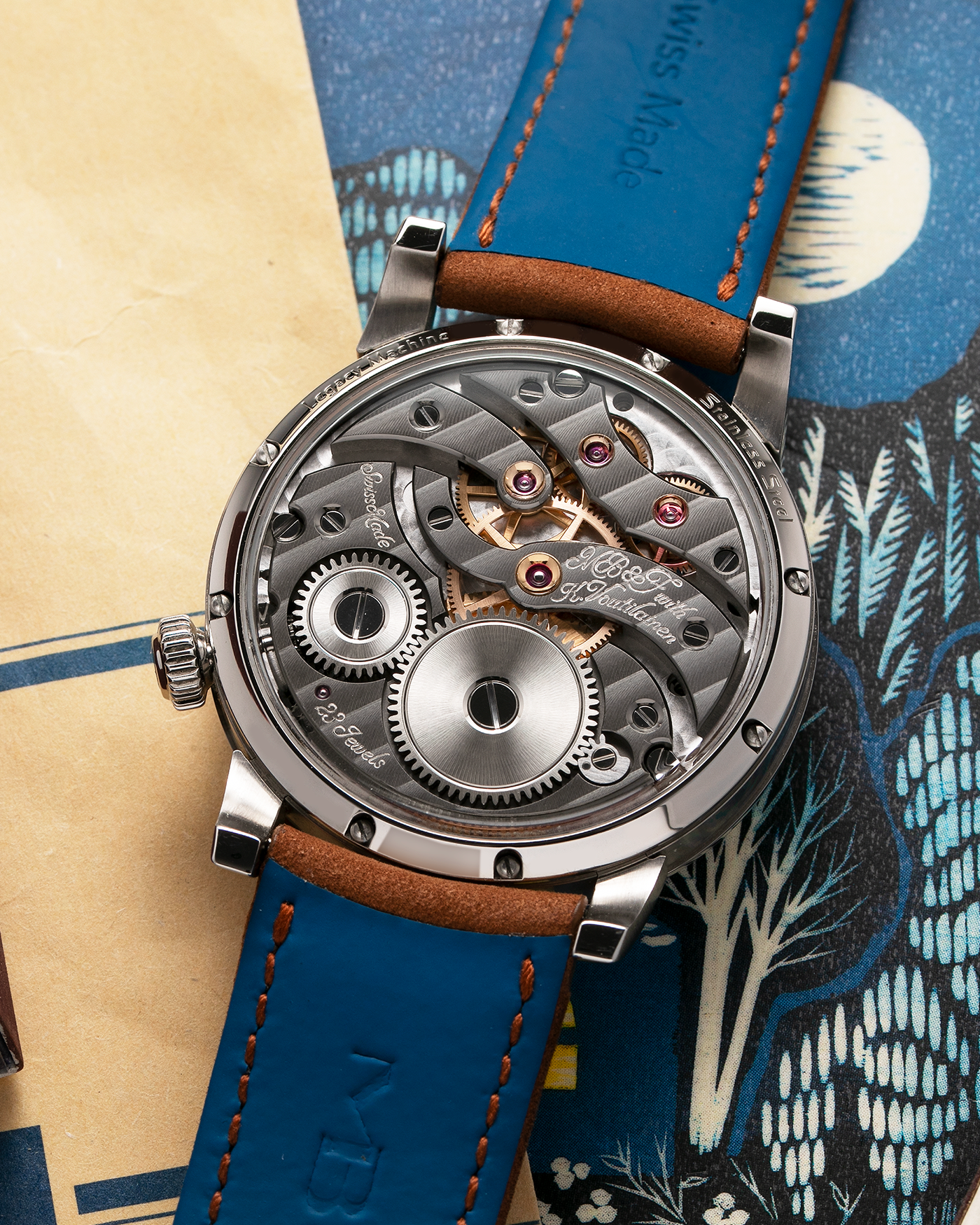 Brand: MB&F Year: 2022 Model: LM101 Steel Blue Material: Stainless Steel with Blue Baseplate Movement: In-House 3-Dimensional MB&F Caliber in Collaboration with Kari Voutilainen, Manual-Winding Case Diameter: 40mm Bracelet/Strap: MB&F Brown Suede Strap and Signed Palladium Deployant Clasp