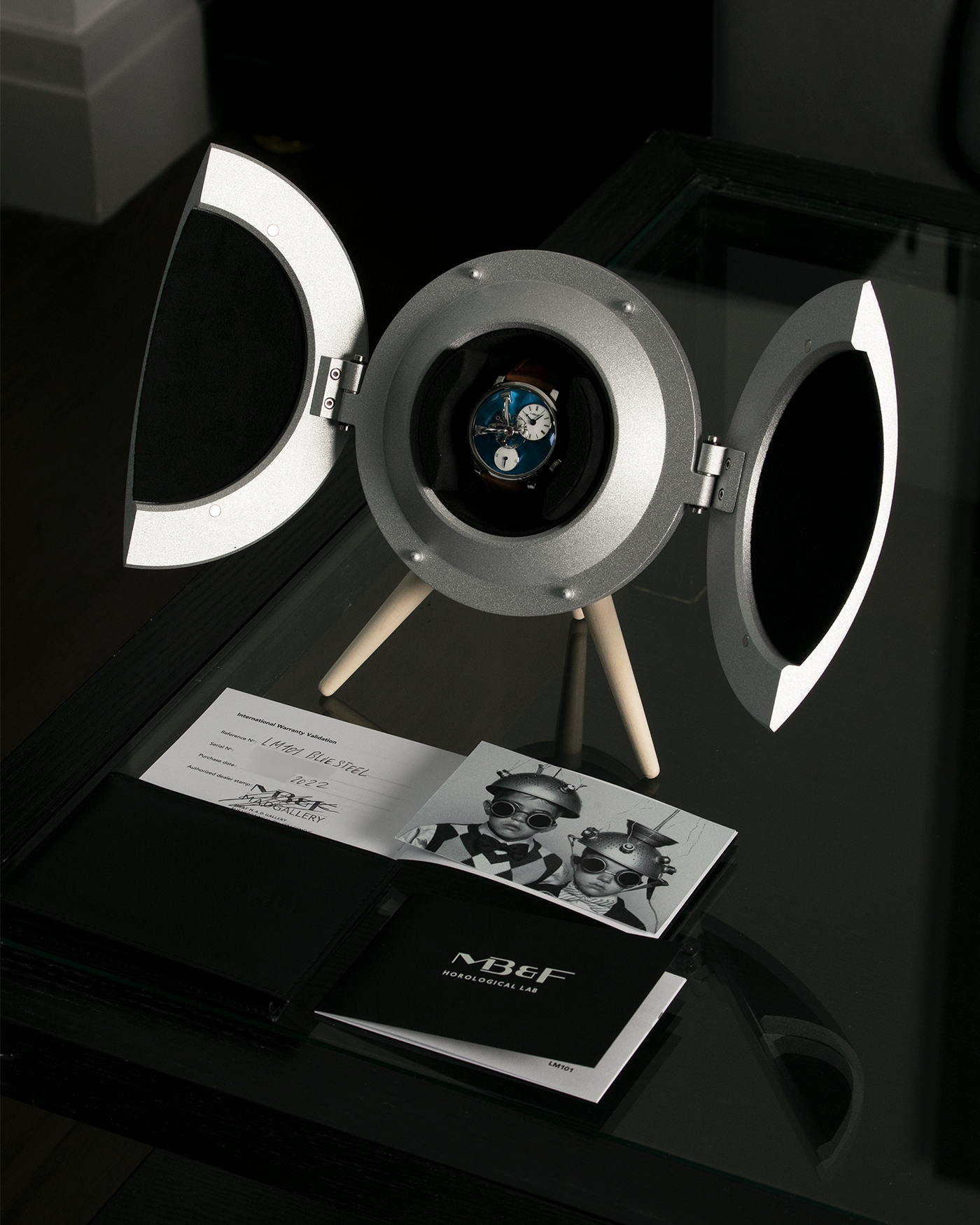 Brand: MB&F Year: 2022 Model: LM101 Steel Blue Material: Stainless Steel with Blue Baseplate Movement: In-House 3-Dimensional MB&F Caliber in Collaboration with Kari Voutilainen, Manual-Winding Case Diameter: 40mm Bracelet/Strap: MB&F Brown Suede Strap and Signed Palladium Deployant Clasp