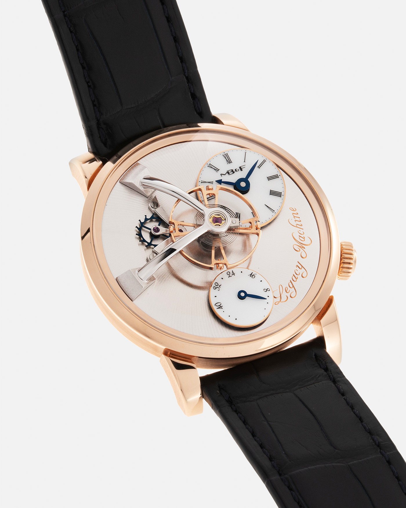 Brand: MB&F Year: 2022 Model: Legacy Machine 101 ‘Red Gold’ Reference: 51.RL.W Material: 18-carat Red Gold Movement: In-House 3-Dimensional MB&F Caliber in Collaboration with Kari Voutilainen, Manual-Winding Case Dimensions: 40mm x 16mm Lug Width: 21mm Strap: MB&F Dark Navy Alligator Strap and Signed Palladium Deployant Clasp