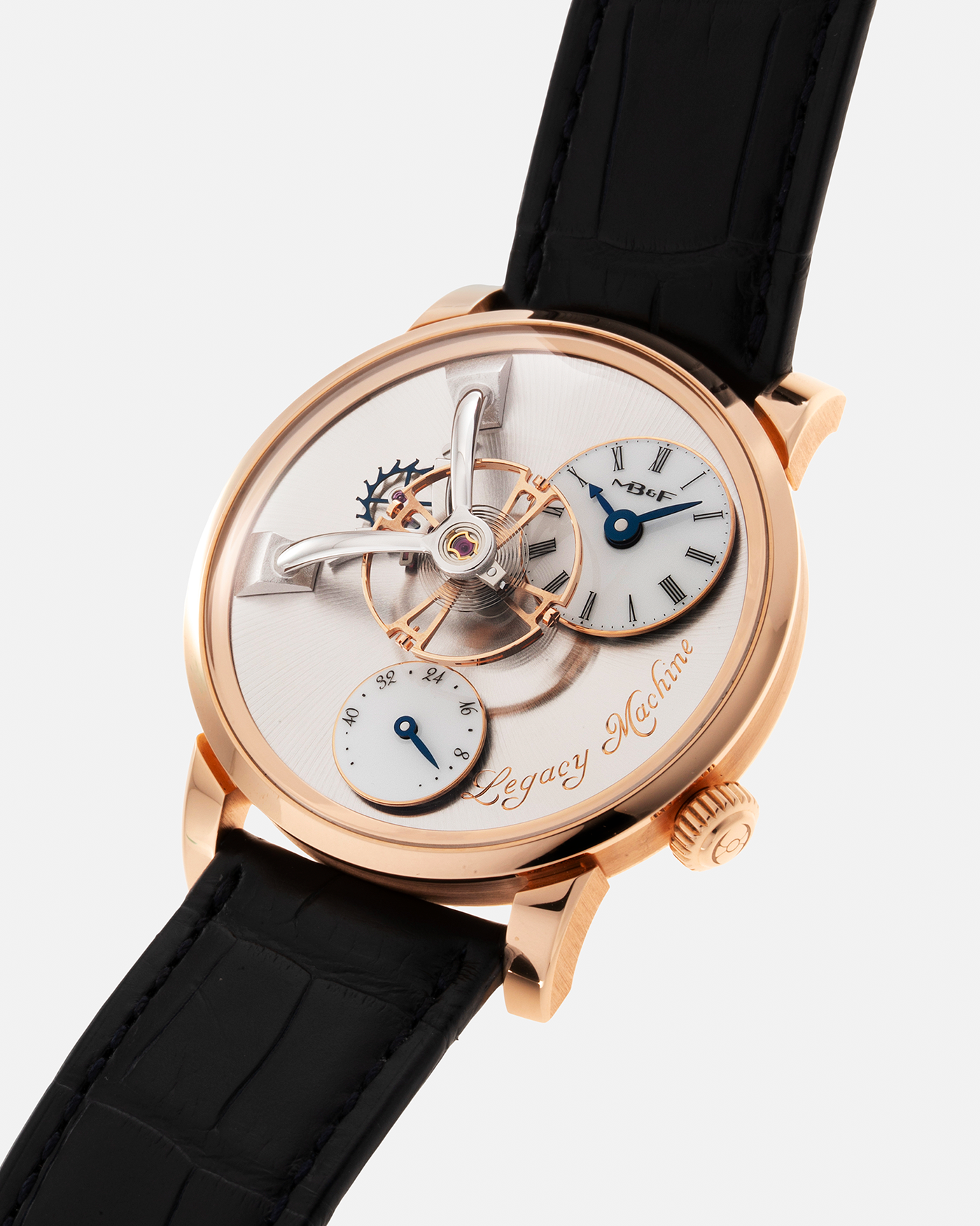 Brand: MB&F Year: 2022 Model: Legacy Machine 101 ‘Red Gold’ Reference: 51.RL.W Material: 18-carat Red Gold Movement: In-House 3-Dimensional MB&F Caliber in Collaboration with Kari Voutilainen, Manual-Winding Case Dimensions: 40mm x 16mm Lug Width: 21mm Strap: MB&F Dark Navy Alligator Strap and Signed Palladium Deployant Clasp