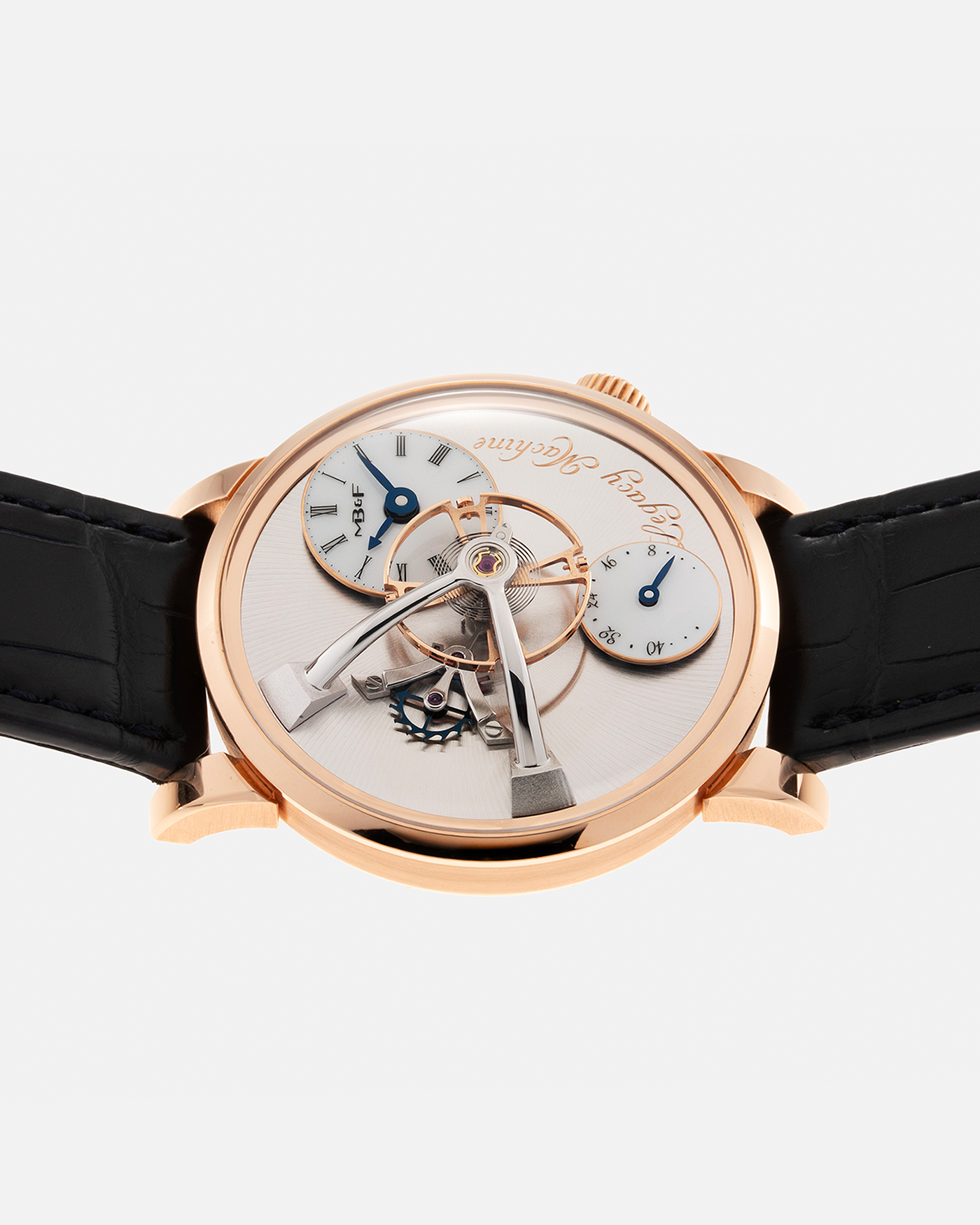 Brand: MB&F Year: 2022 Model: Legacy Machine 101 ‘Red Gold’ Reference: 51.RL.W Material: 18-carat Red Gold Movement: In-House 3-Dimensional MB&F Caliber in Collaboration with Kari Voutilainen, Manual-Winding Case Dimensions: 40mm x 16mm Lug Width: 21mm Strap: MB&F Dark Navy Alligator Strap and Signed Palladium Deployant Clasp