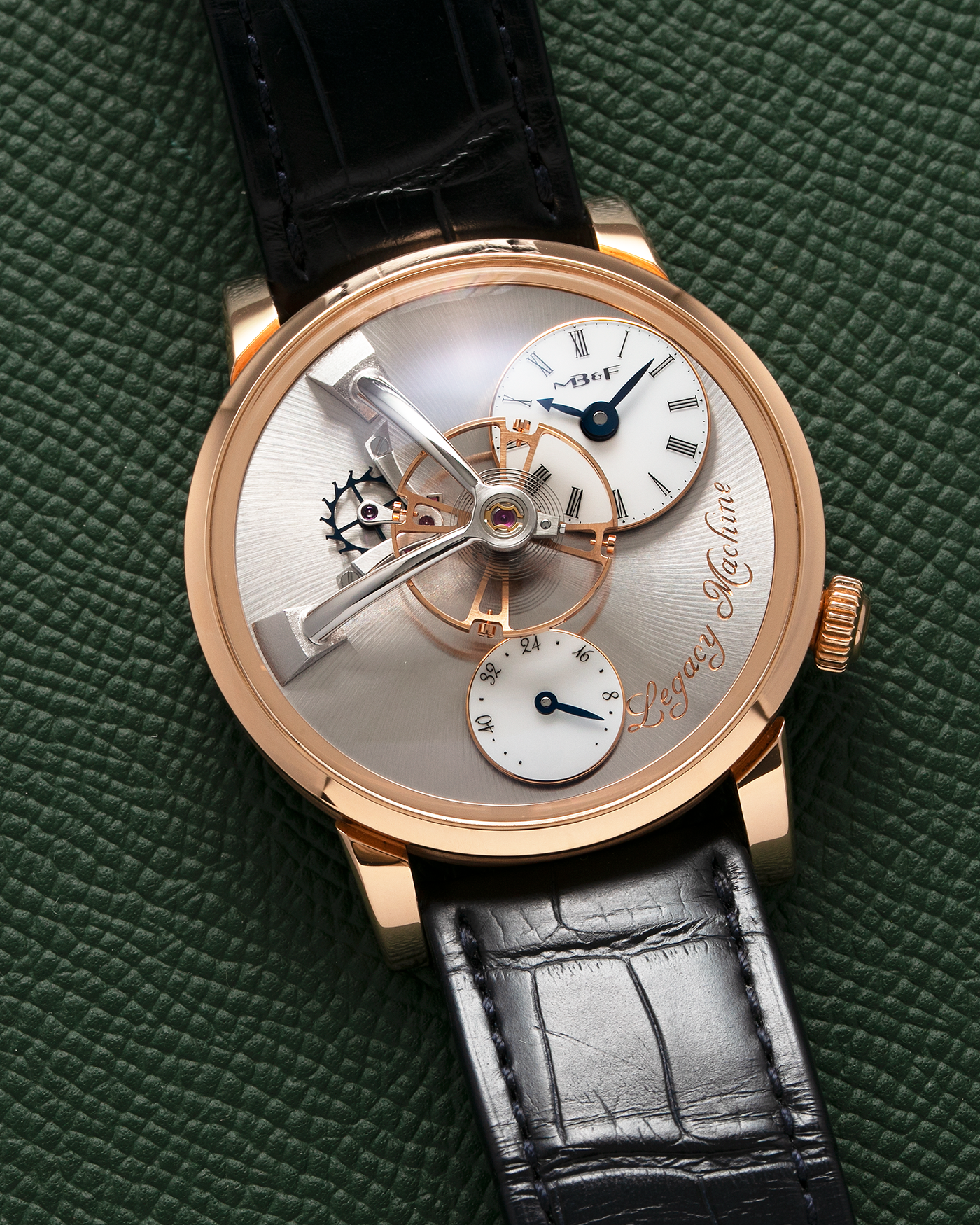Brand: MB&F Year: 2022 Model: Legacy Machine 101 ‘Red Gold’ Reference: 51.RL.W Material: 18-carat Red Gold Movement: In-House 3-Dimensional MB&F Caliber in Collaboration with Kari Voutilainen, Manual-Winding Case Dimensions: 40mm x 16mm Lug Width: 21mm Strap: MB&F Dark Navy Alligator Strap and Signed Palladium Deployant Clasp