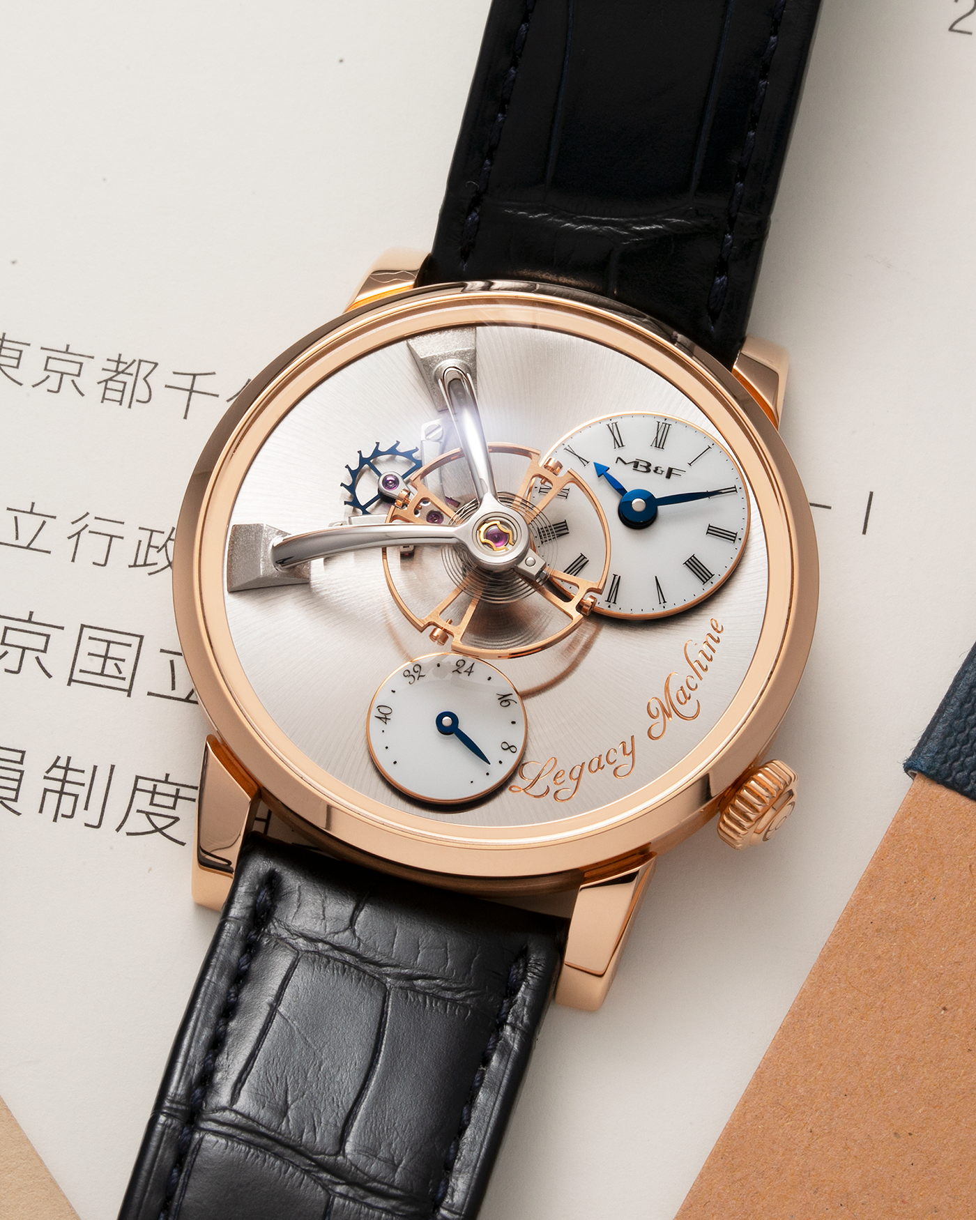Brand: MB&F Year: 2022 Model: Legacy Machine 101 ‘Red Gold’ Reference: 51.RL.W Material: 18-carat Red Gold Movement: In-House 3-Dimensional MB&F Caliber in Collaboration with Kari Voutilainen, Manual-Winding Case Dimensions: 40mm x 16mm Lug Width: 21mm Strap: MB&F Dark Navy Alligator Strap and Signed Palladium Deployant Clasp