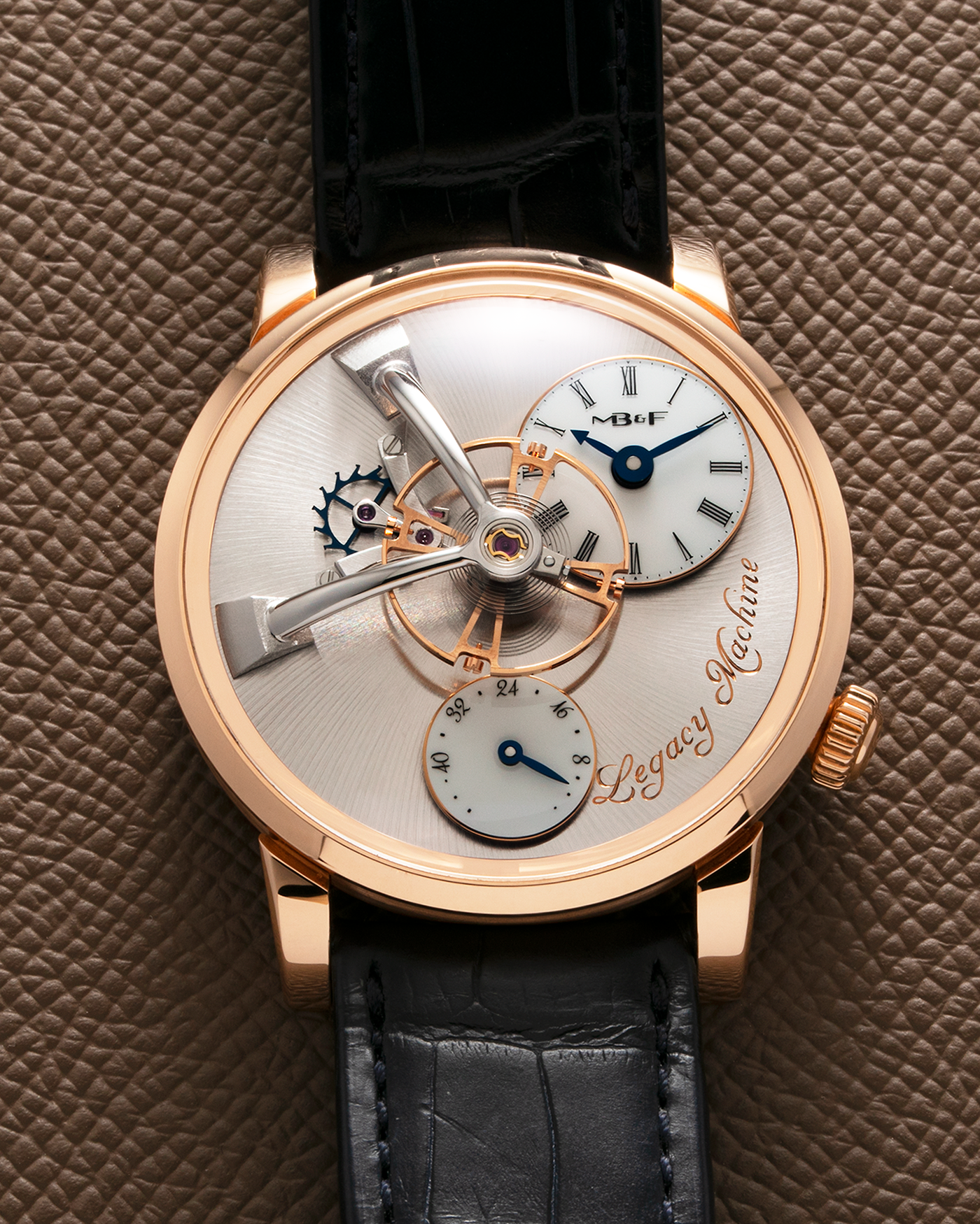 Brand: MB&F Year: 2022 Model: Legacy Machine 101 ‘Red Gold’ Reference: 51.RL.W Material: 18-carat Red Gold Movement: In-House 3-Dimensional MB&F Caliber in Collaboration with Kari Voutilainen, Manual-Winding Case Dimensions: 40mm x 16mm Lug Width: 21mm Strap: MB&F Dark Navy Alligator Strap and Signed Palladium Deployant Clasp