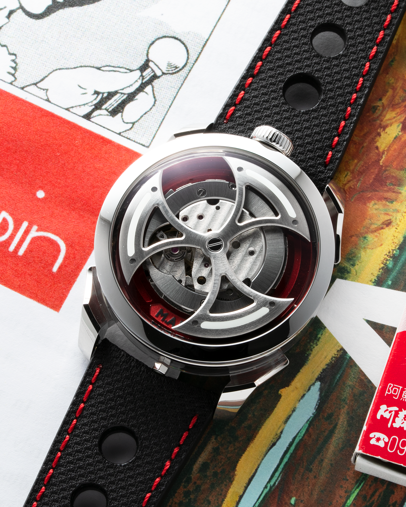 Brand: MB&F Year: 2022 Model: MAD 1 Material: Stainless Steel and Titanium Movement: Miyota Cal 821A Case Diameter: 42mm Bracelet/Strap: MB&F Black Calfskin Leather with Red Stitching and Stainless Steel Deployant Buckle